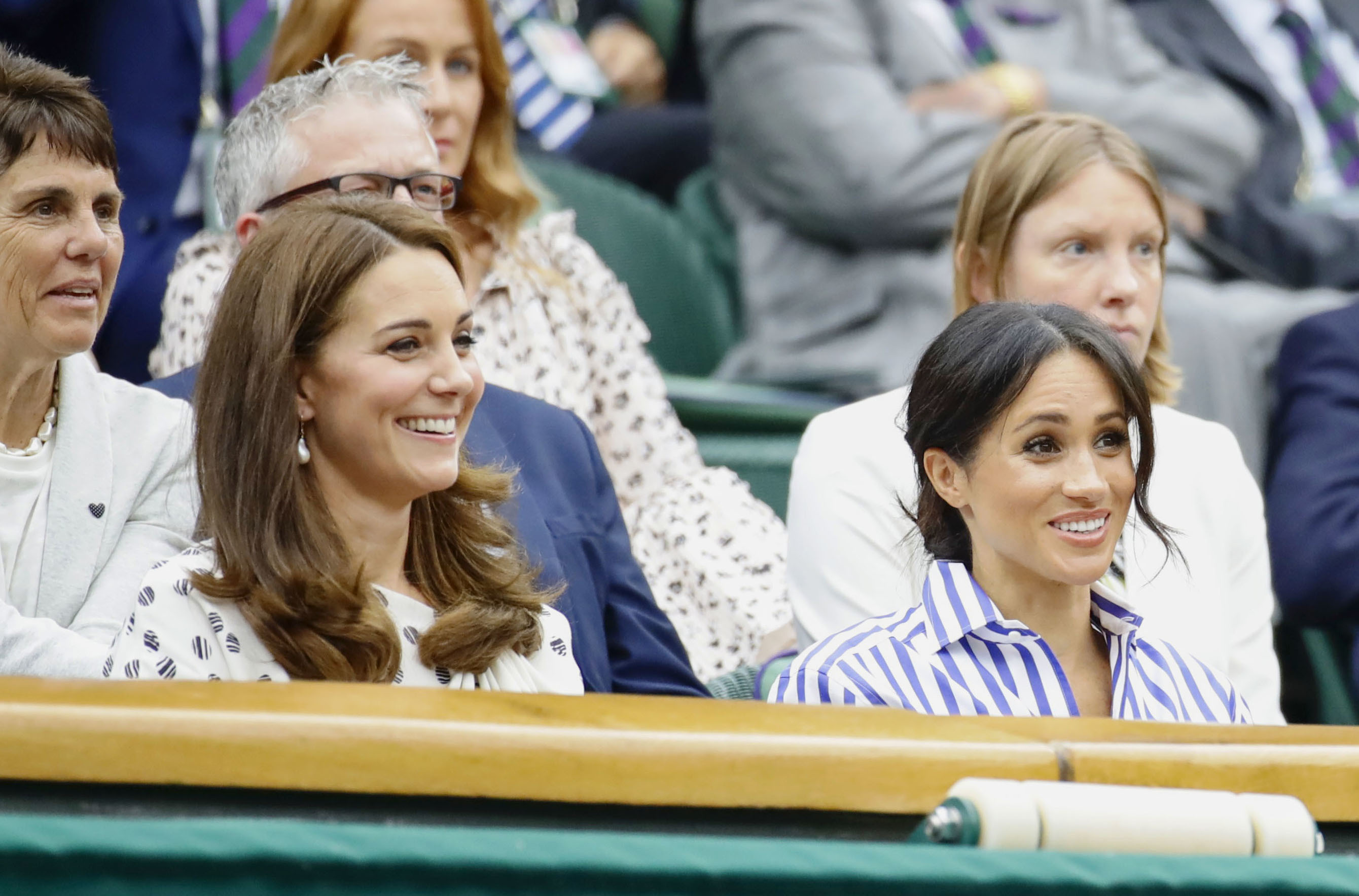 Princess Catherine and Meghan Markle on day twelve of the Wimbledon Tennis Championships at the All England Lawn Tennis and Croquet Club on July 14, 2018 in London, England | Source: Getty Images