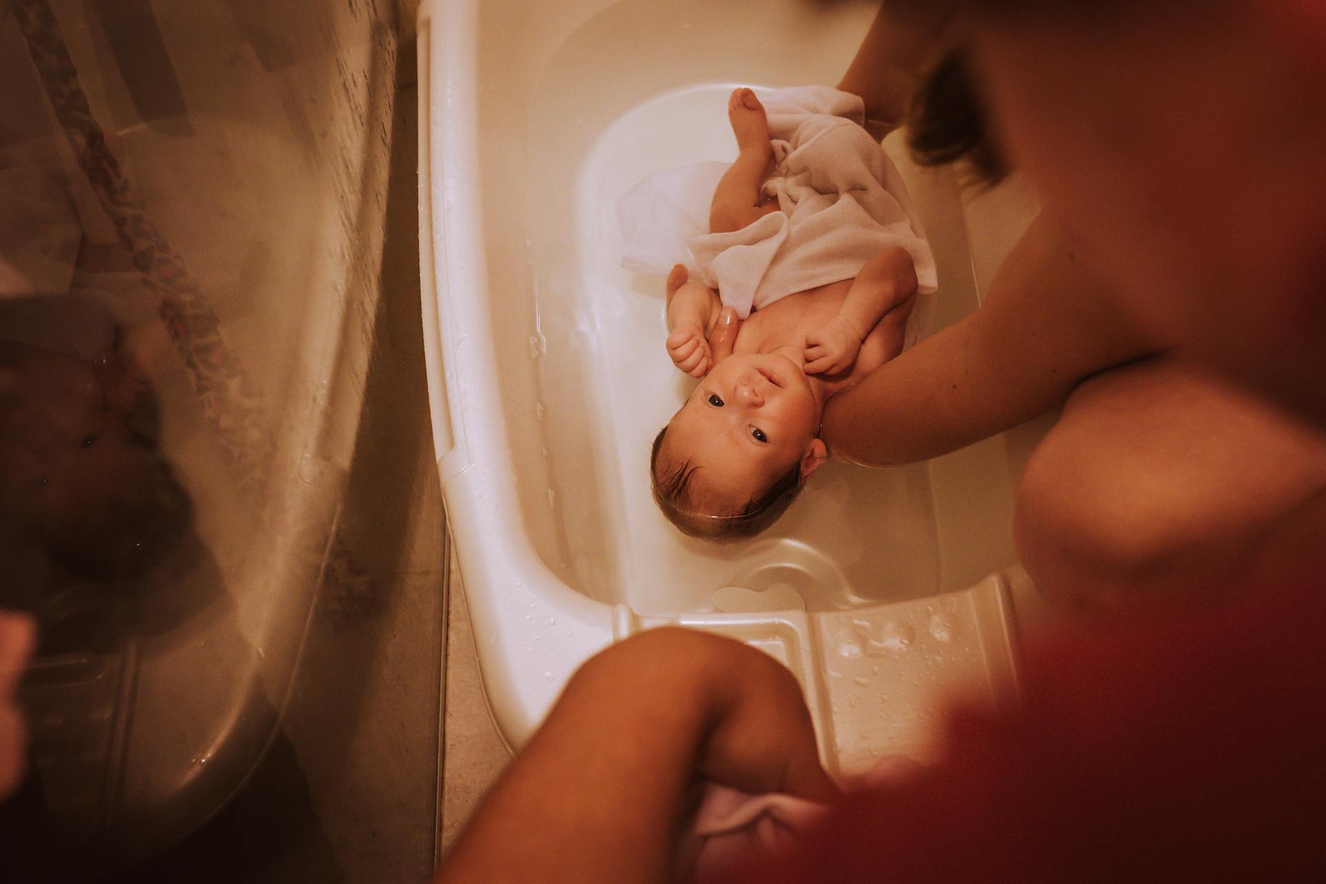 A person bathing a baby | Source: Pexels