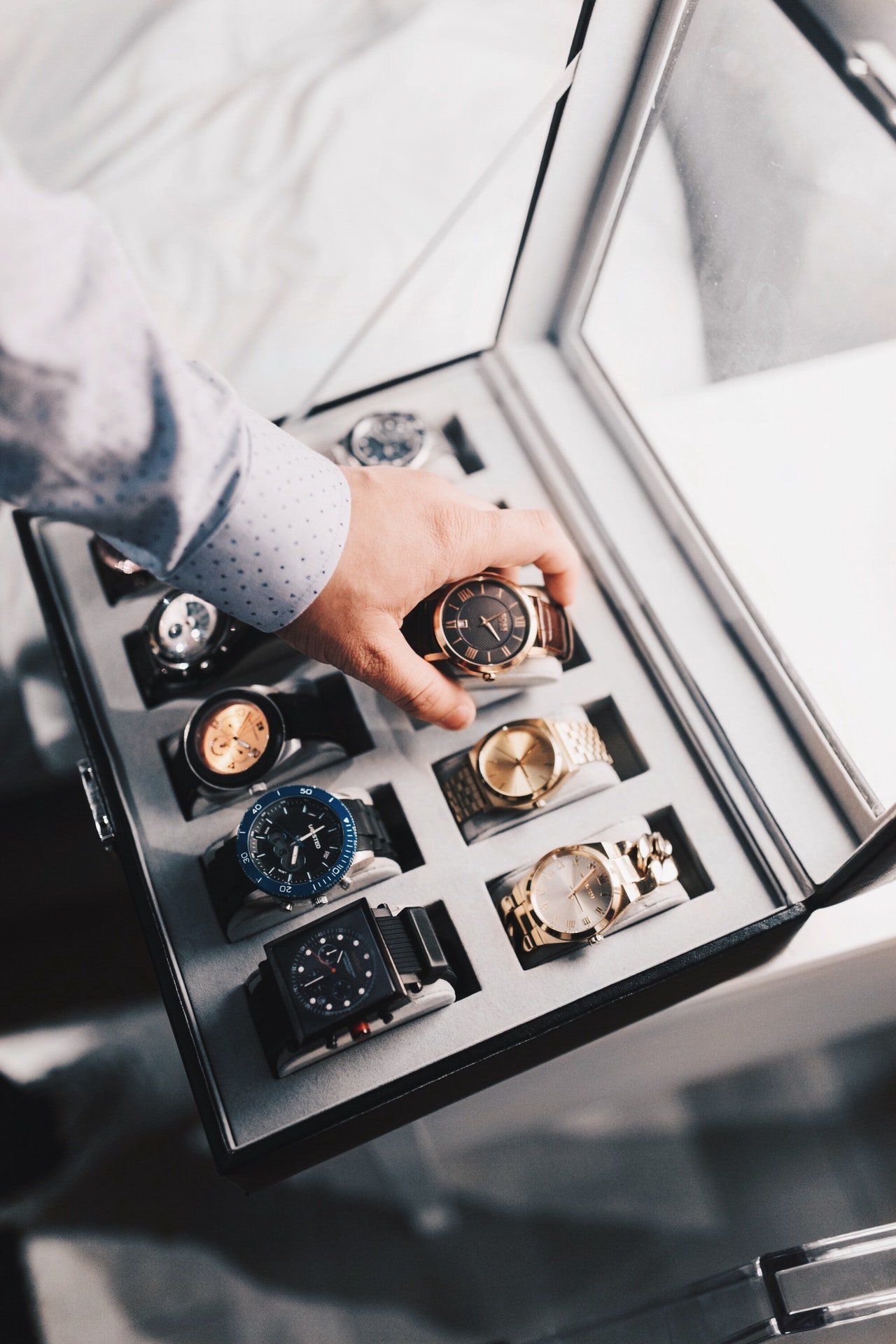 Collection of watches in a display case | Photo: Pexels