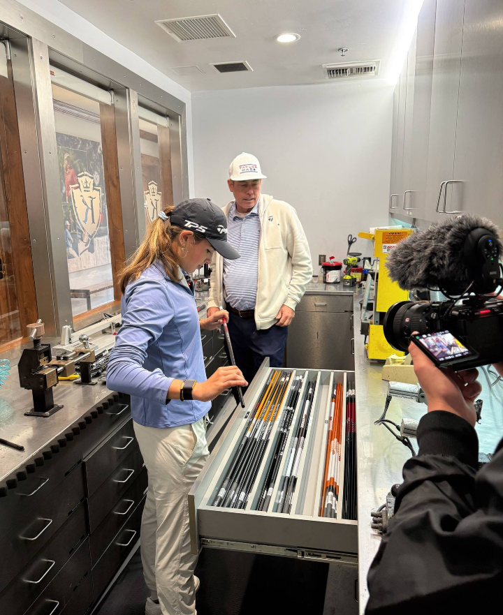 Kai examines golf shafts, focused on the details as a camera crew documents the moment | Source: Facebook/Kai-Trump