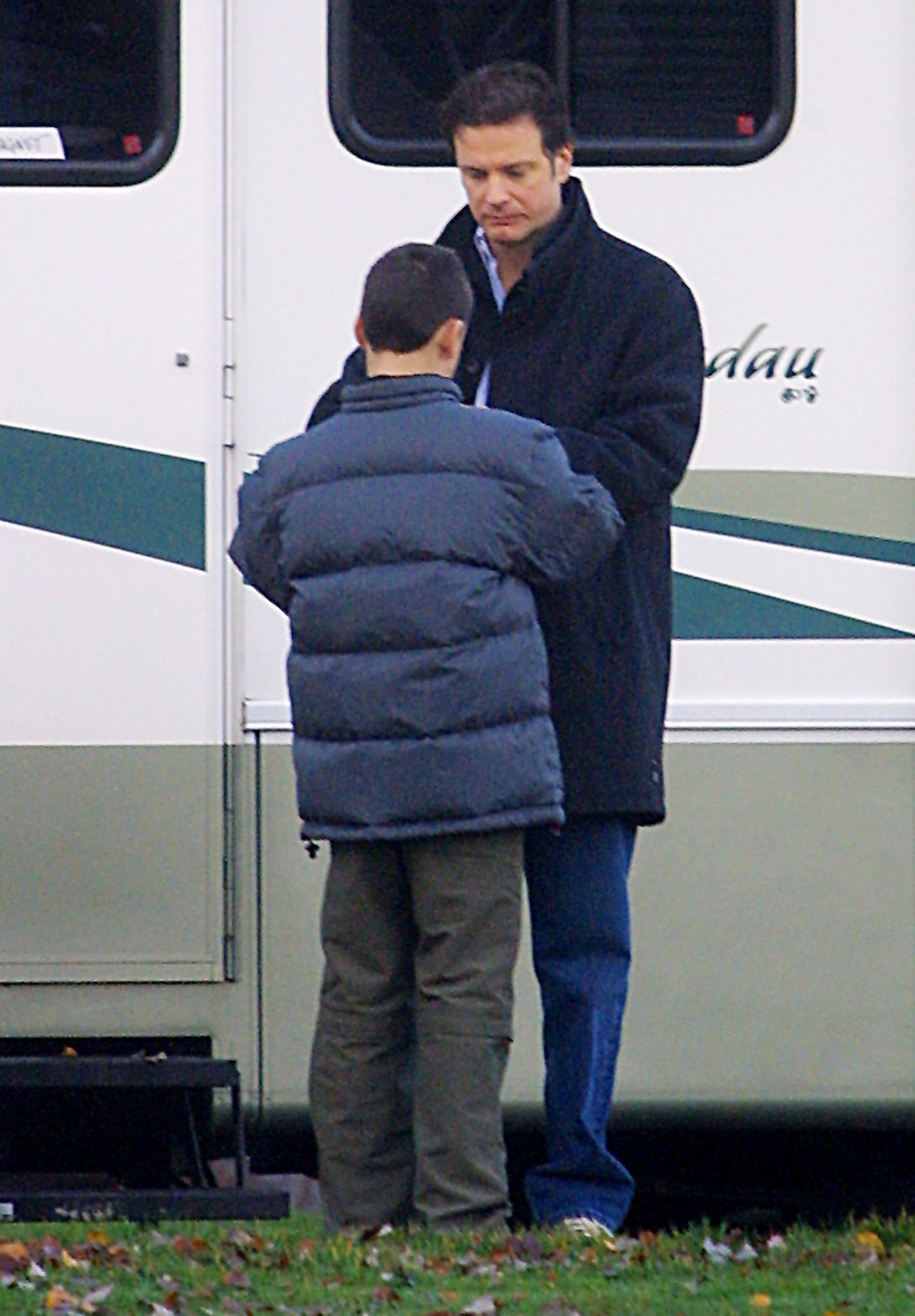Colin Firth and his son Will Firth stand outside the trailer on the set of "New Cardiff" November 26, 2001, in Vancouver, British Columbia. | Source: Getty Images