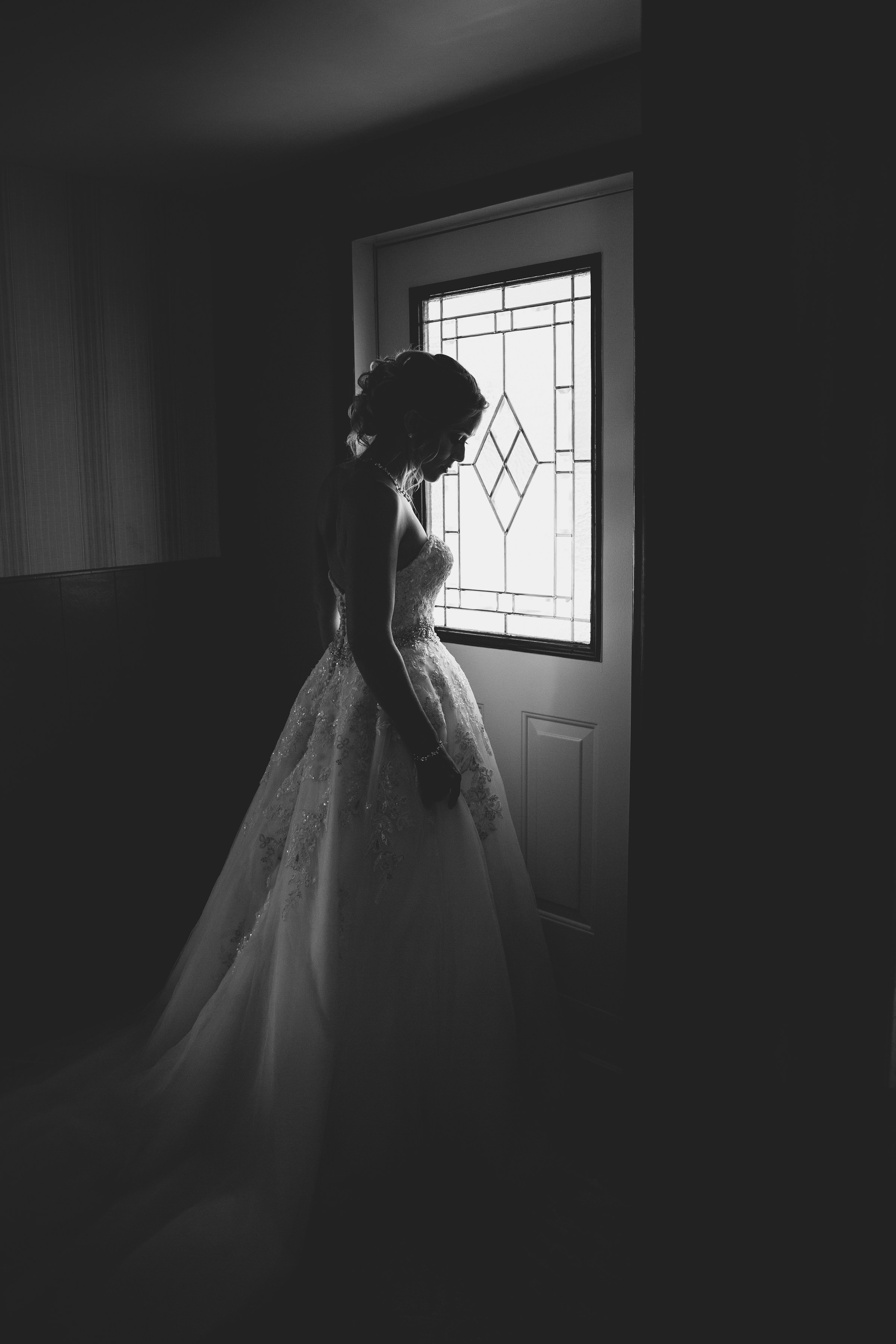 A silhouette of a bride standing behind a door | Source: Unsplash