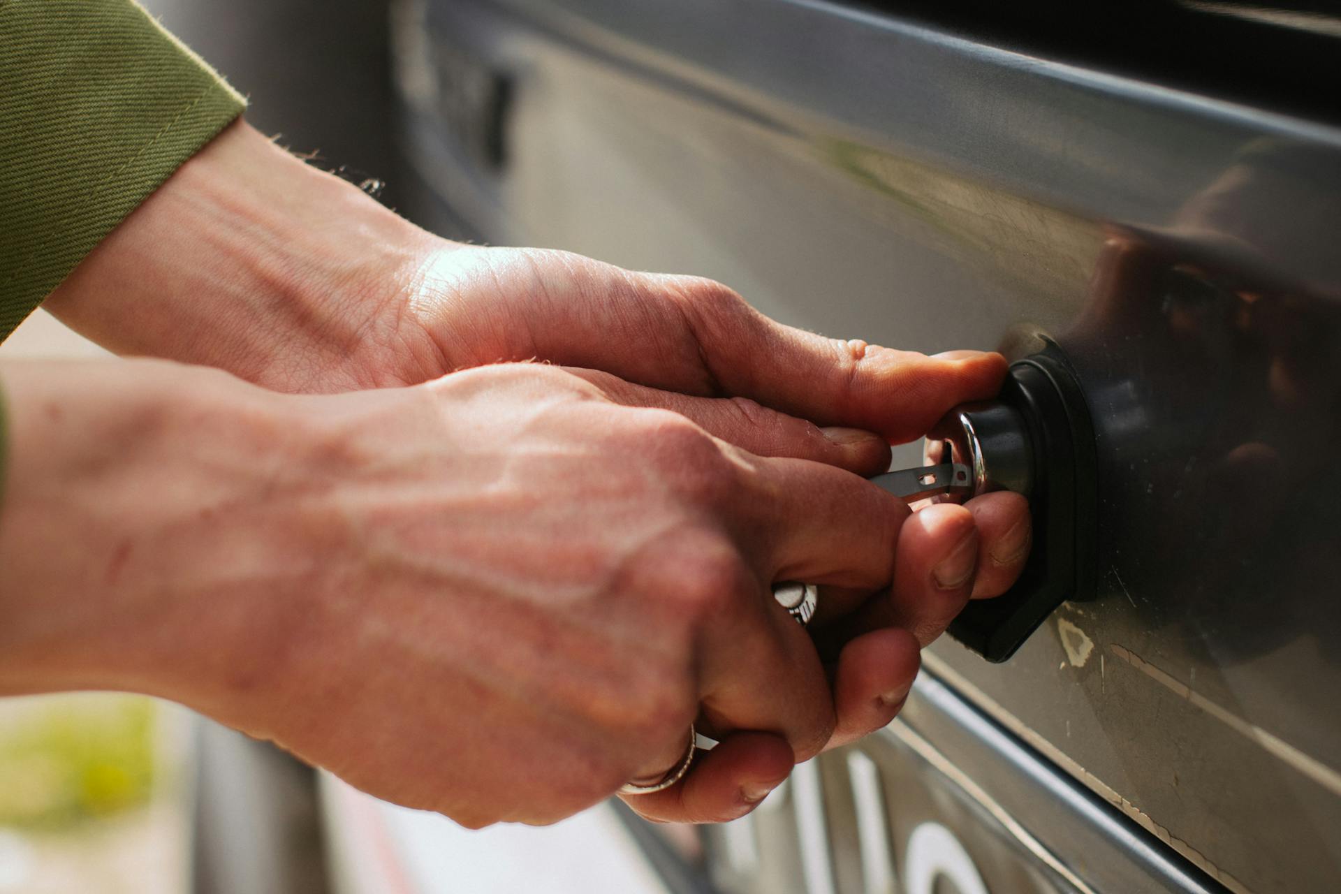 A person unlocking a car door | Source: Pexels