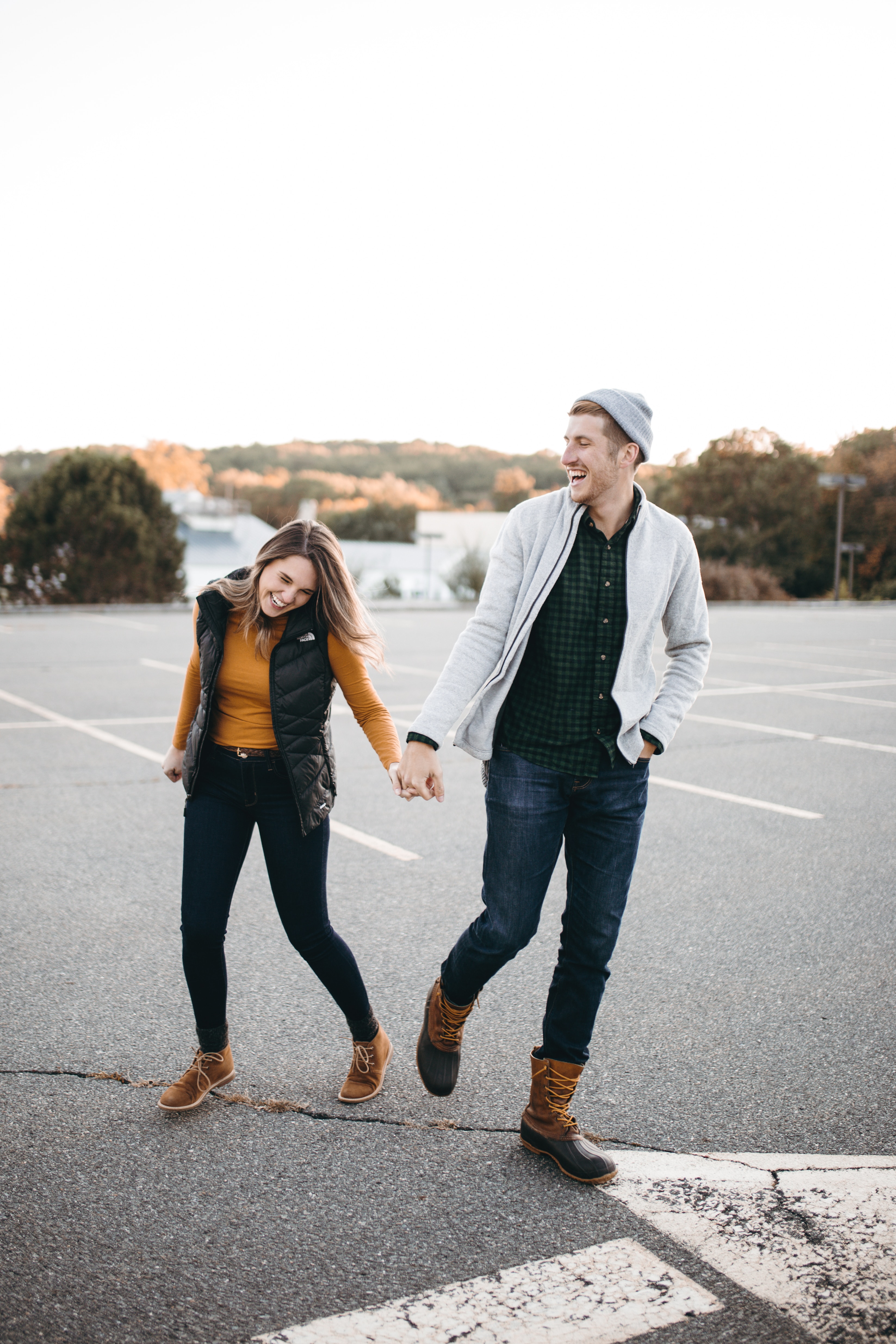 A couple holding hands and laughing. | Source: Unsplash