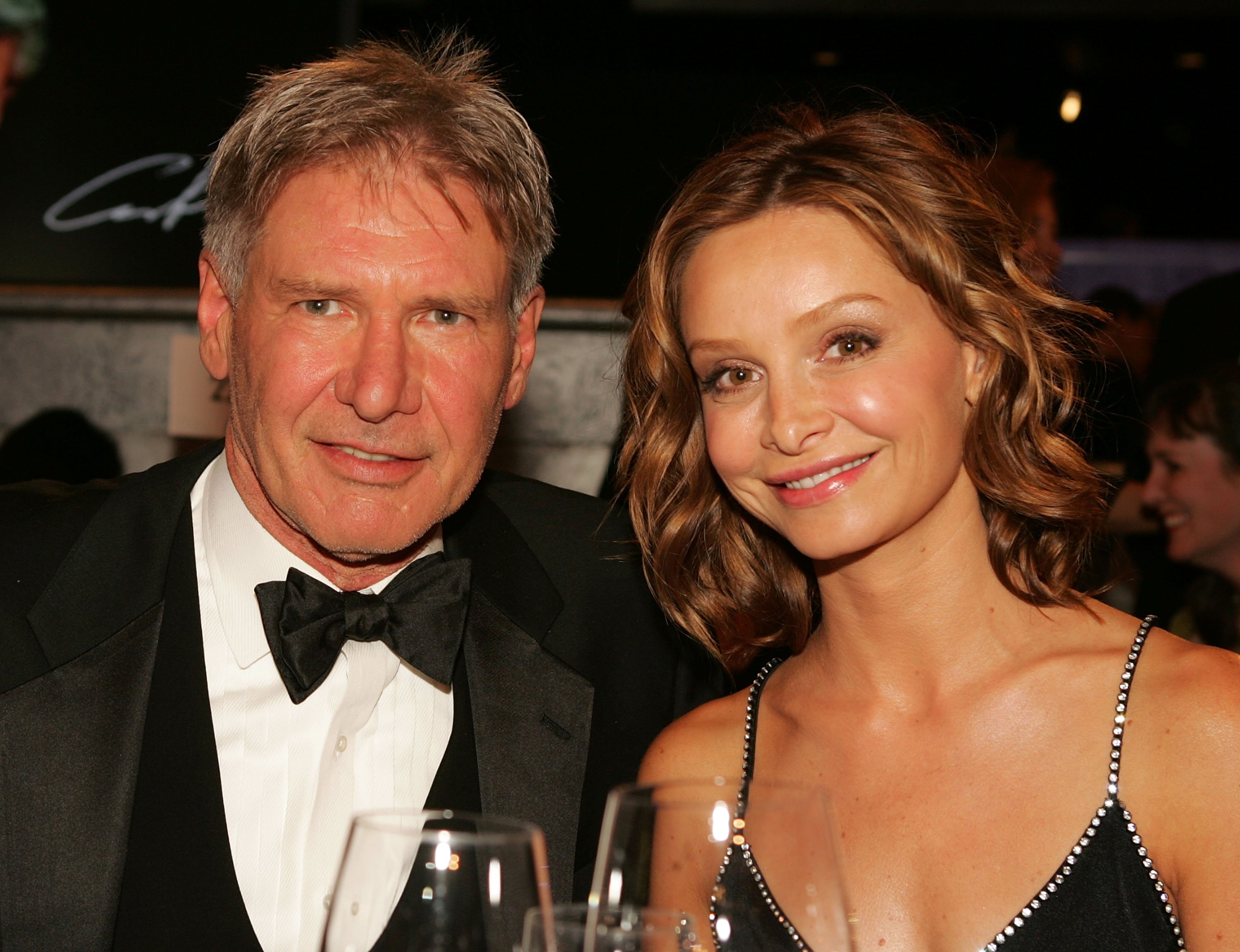 Actors Harrison Ford and Calista Flockhart pose during the 33rd AFI Life Achievement Award tribute to George Lucas at the Kodak Theatre on June 9, 2005 in Hollywood, California.| Source: Getty Images
