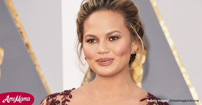 Heavily pregnant Chrissy Teigen flashes her baby bump holding 1-year-old daughter Luna