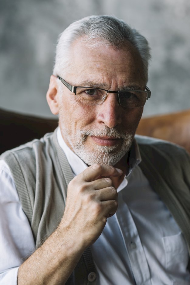 A bearded man with glasses staring at the camera | Source: Freepik