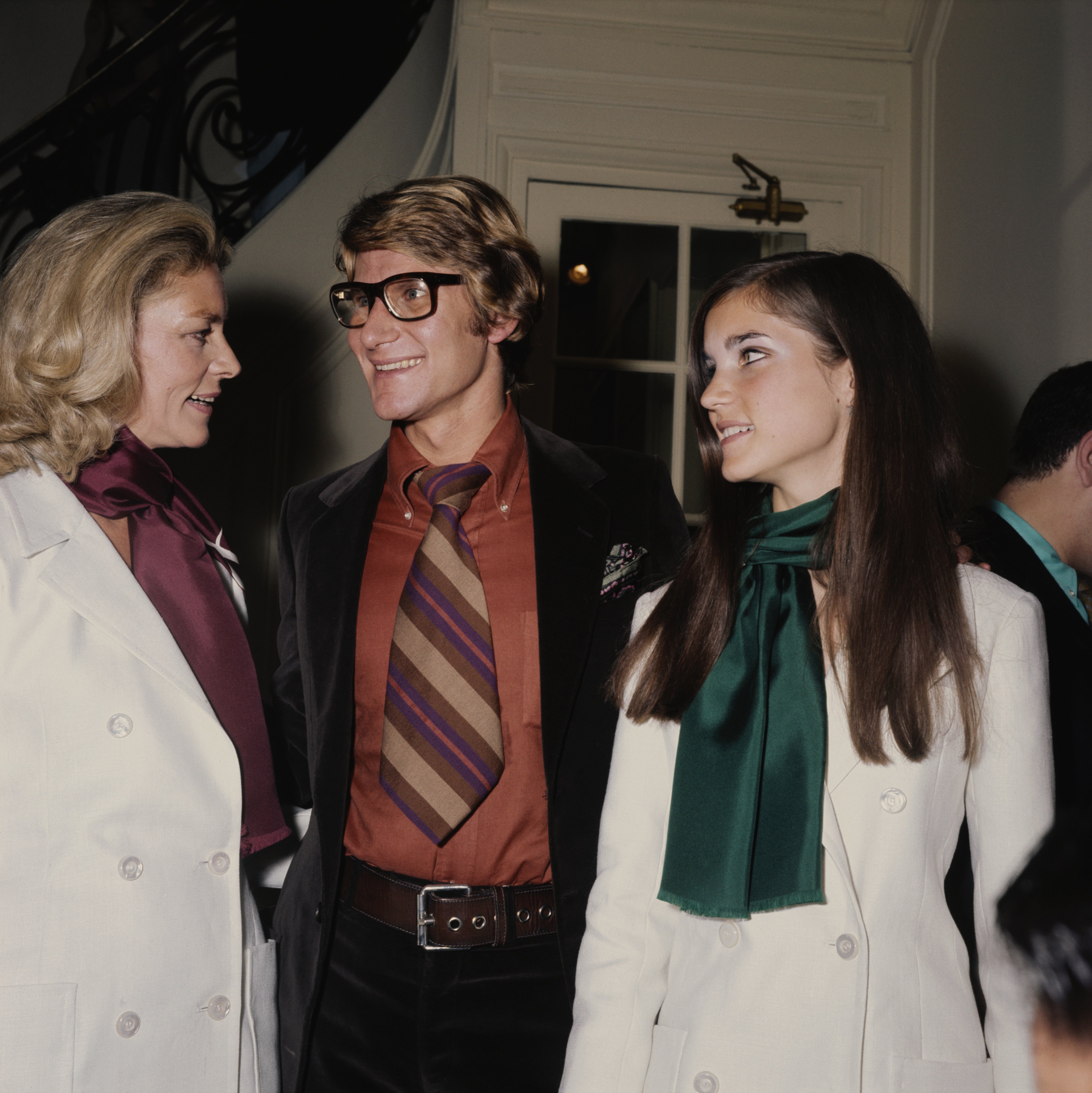  Lauren Bacall and Leslie Bogart with French fashion designer Yves Saint Laurent at a showing of the designer's latest collection on July 30, 1968, in Paris, France | Source: Getty Images