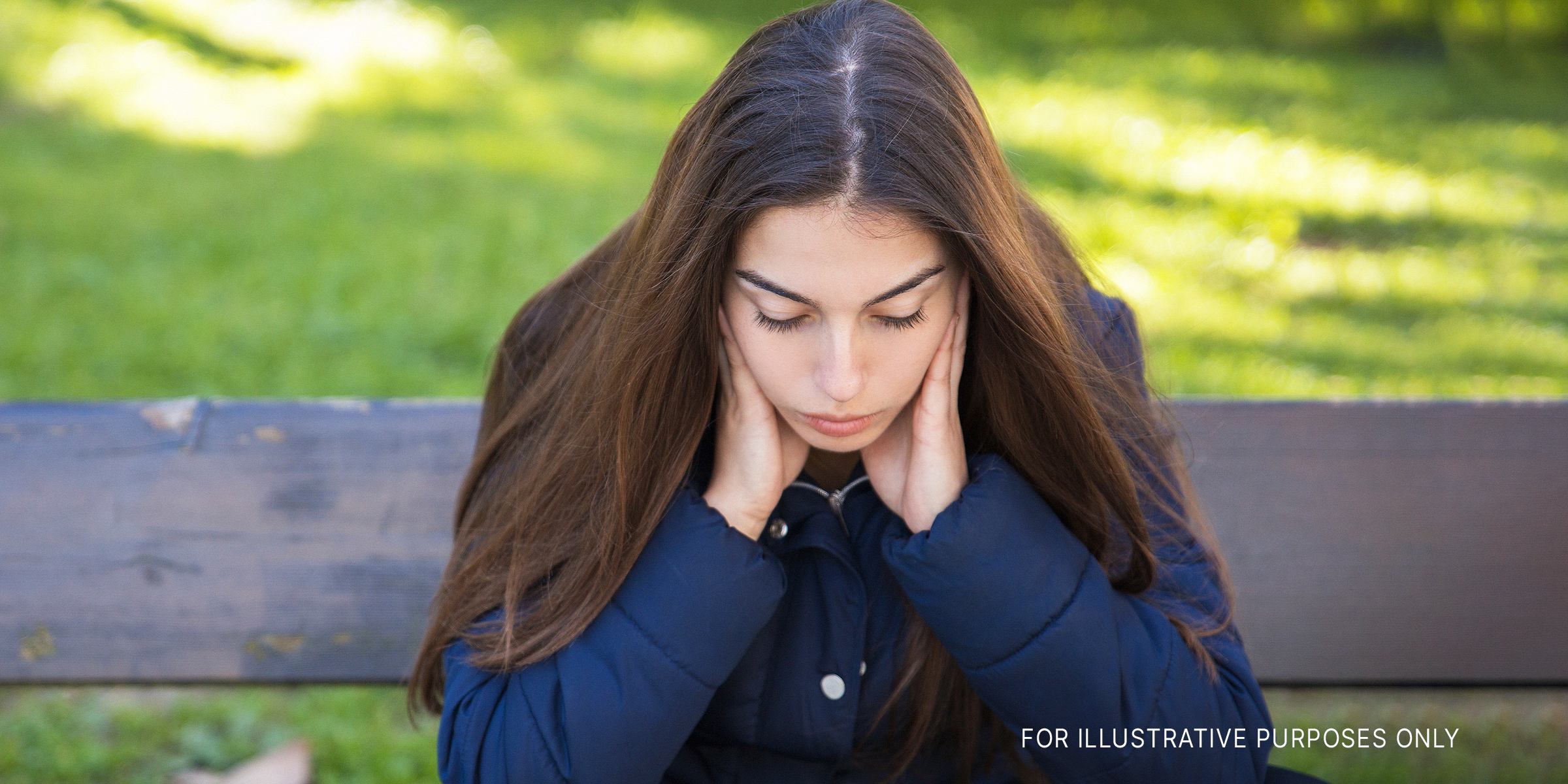 A pensive young woman sitting on a bench in a park | Source: Freepik