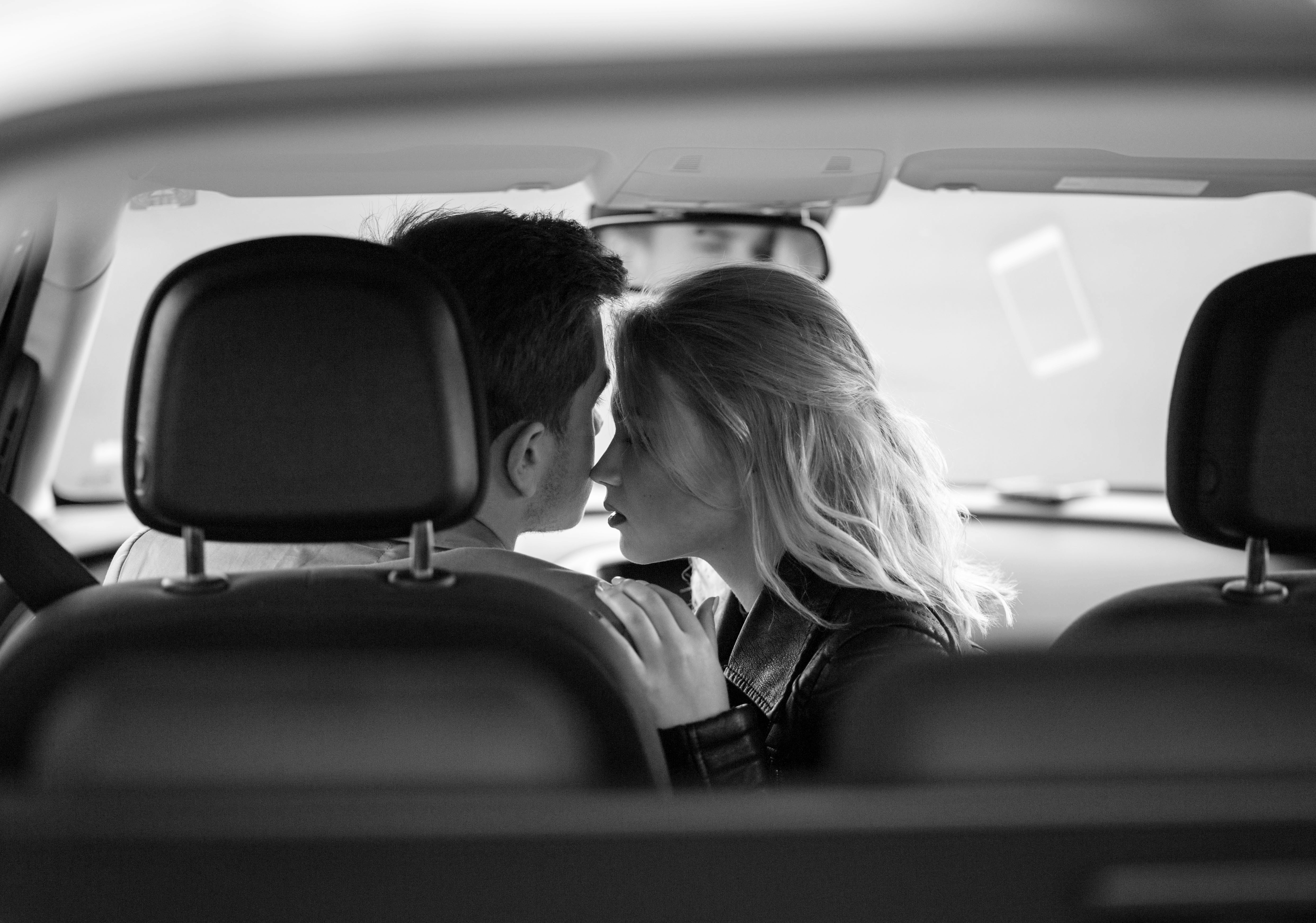 Couple romantic kissing in car. | Source: Shutterstock
