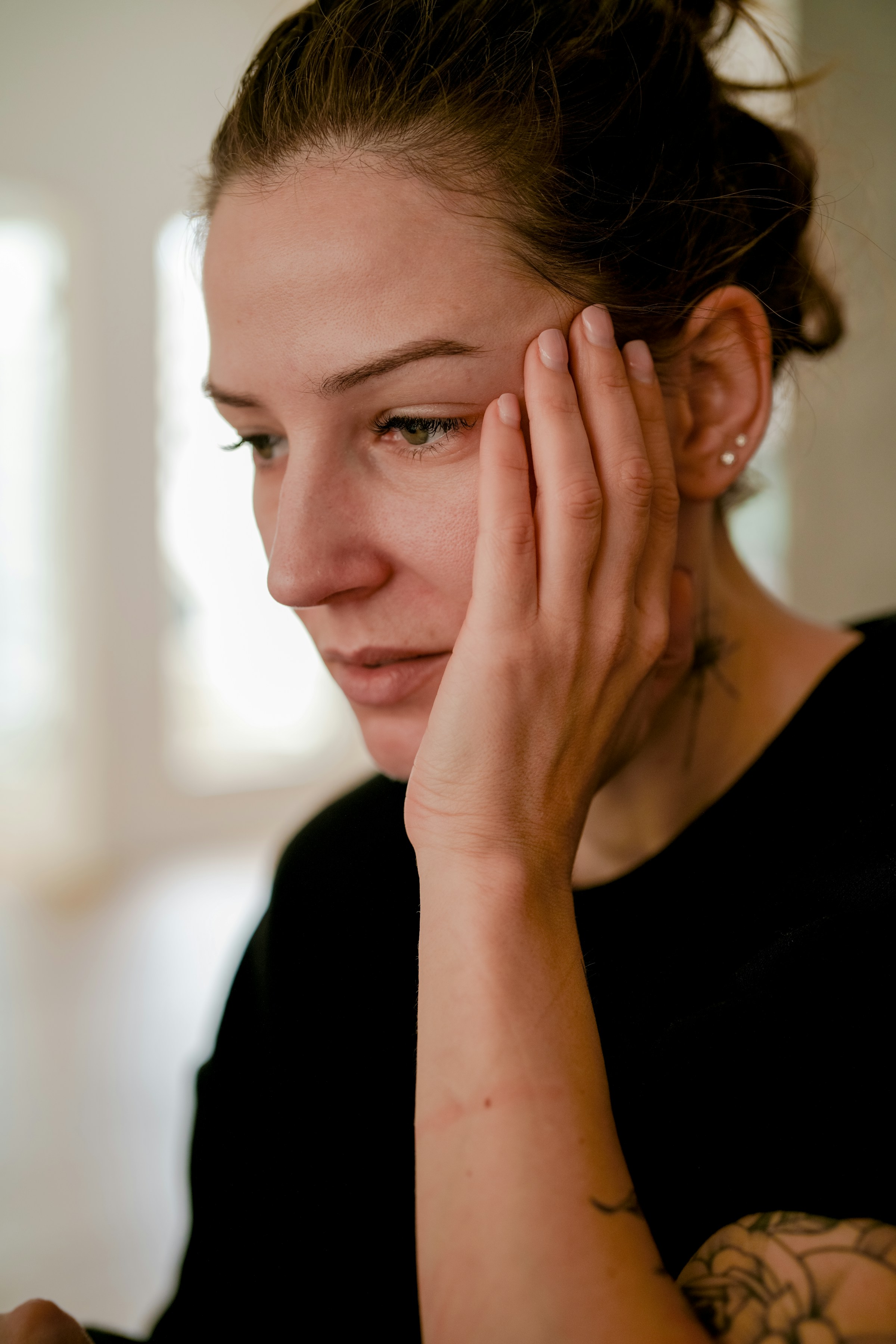 A stressed woman with her hand on her face | Source: Unsplash