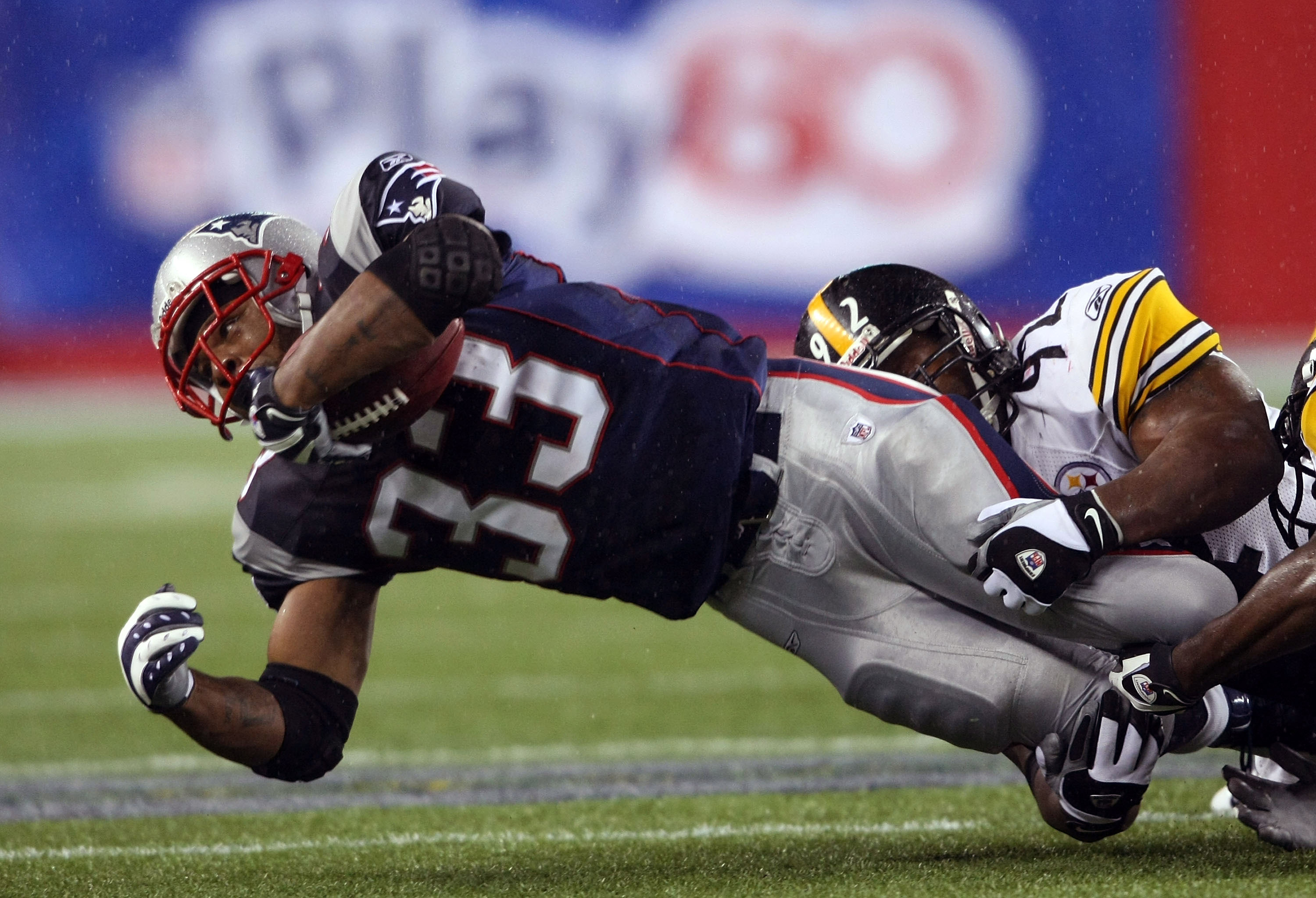 Kevin Faulk is taken down by James Harrison #92 of the Pittsburgh Steelers on November 30, 2008, at Gillette Stadium in Foxboro, Massachusetts | Source: Getty Images