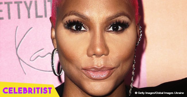 Tamar Braxton flaunts deep cleavage and shapely legs in black dress after recent weight loss