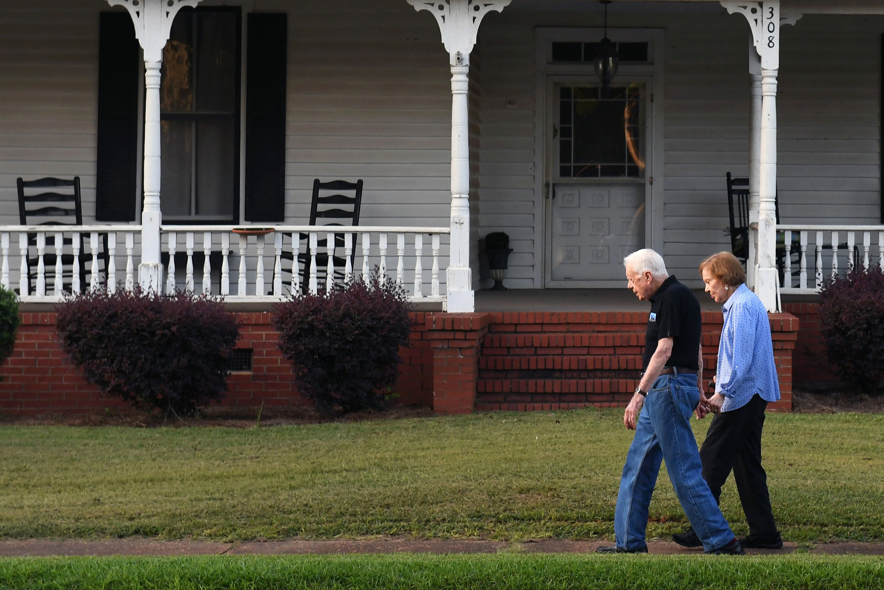 Former President of the United States, Jimmy Carter walks with his wife, former First Lady Rosalynn Carter, along with Secret Service on West Church Street after dinner at a friend's home on August 4, 2018, in Plains, Georgia | Source: Getty Images