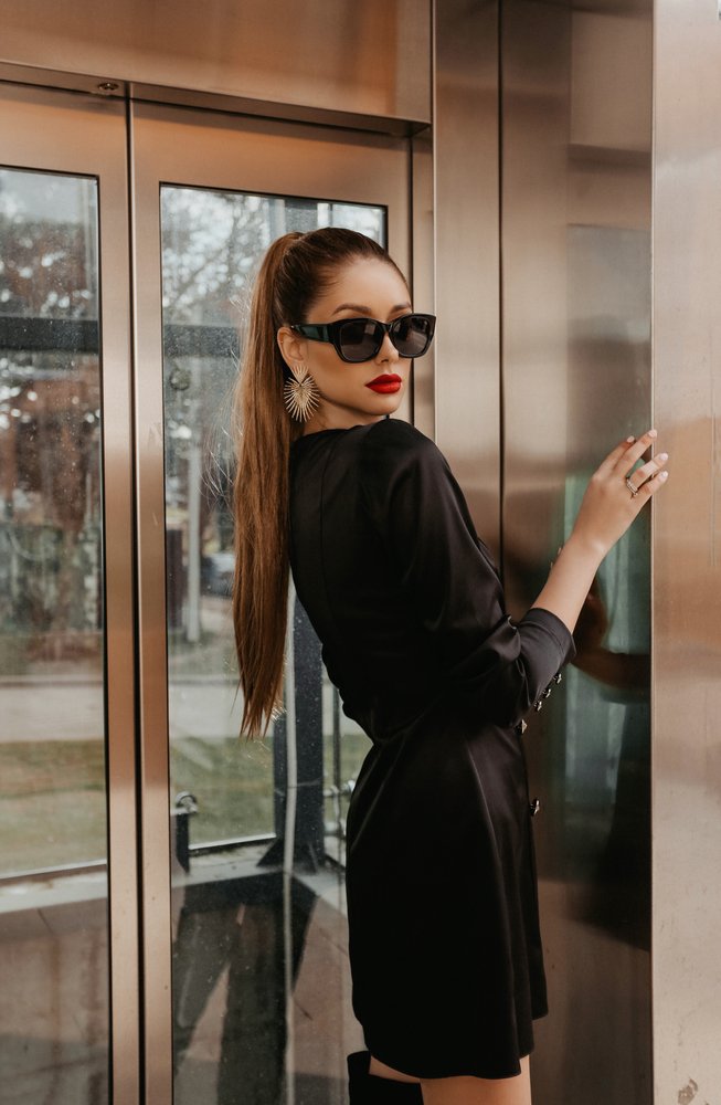 Model with sunglasses inside an elevator | Source: Shutterstock