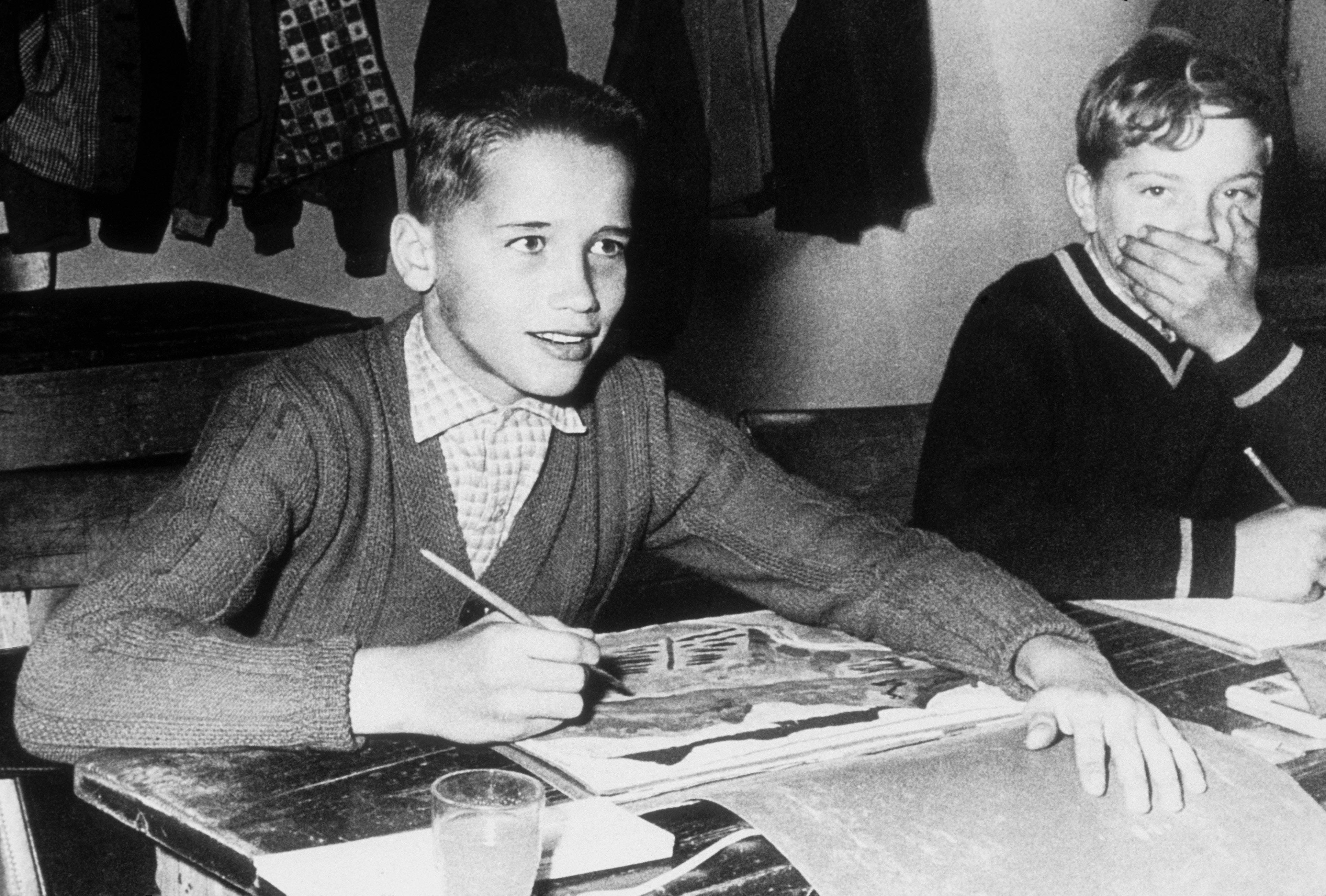 Arnold Schwarzenegger, 11, and another student pose for a photo in art class in 1958 in Thal, Austria | Source: Getty Images