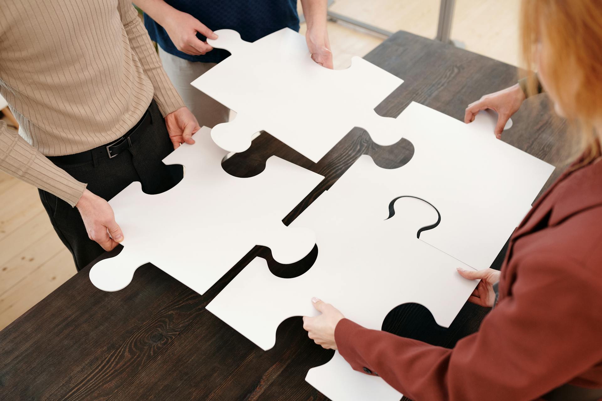 A closeup of people holding puzzle pieces | Source: Pexels