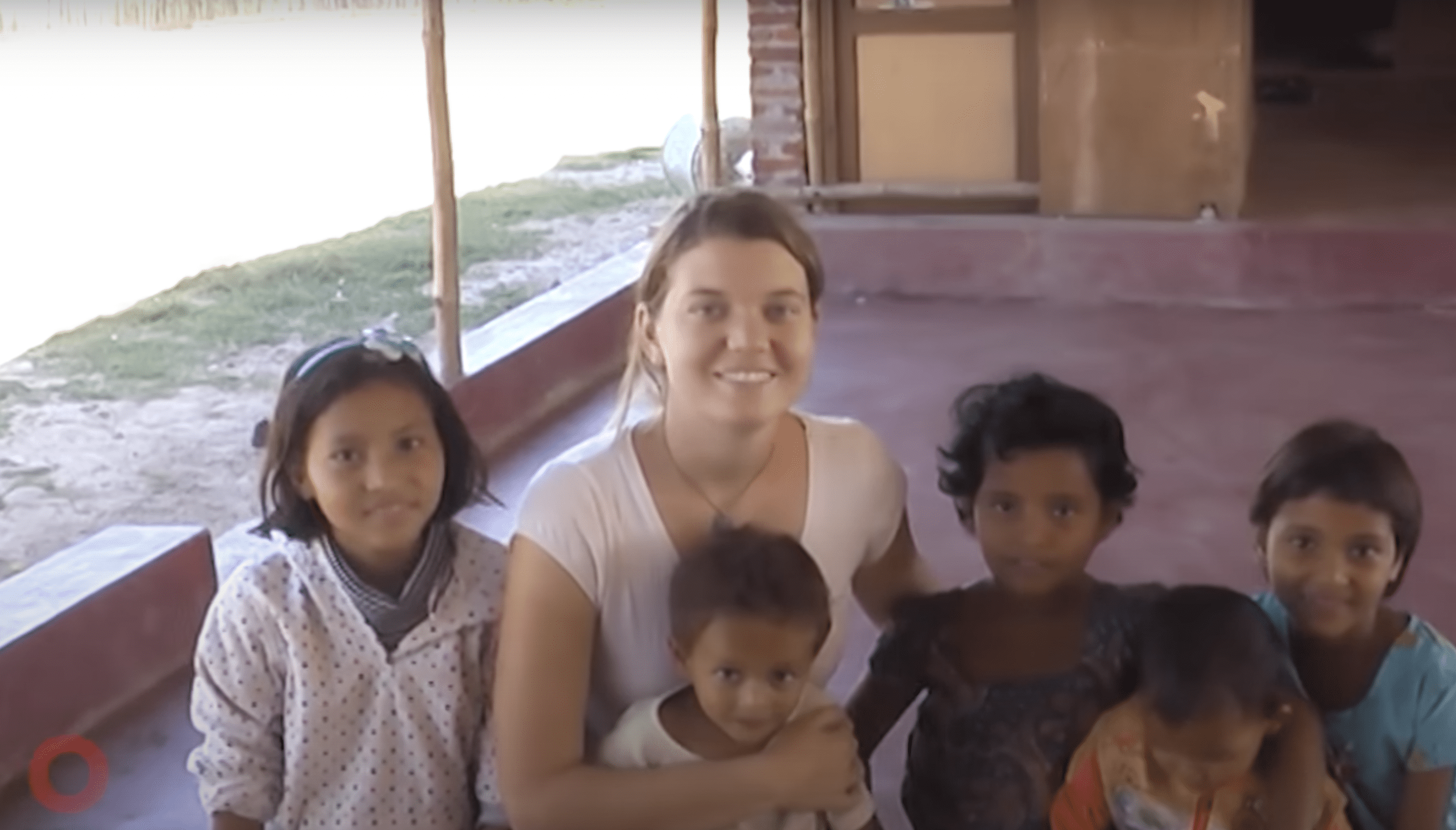 Maggie Doyne pictured with her adopted children in Nepal. | Source: YouTube.com/Global Citizen