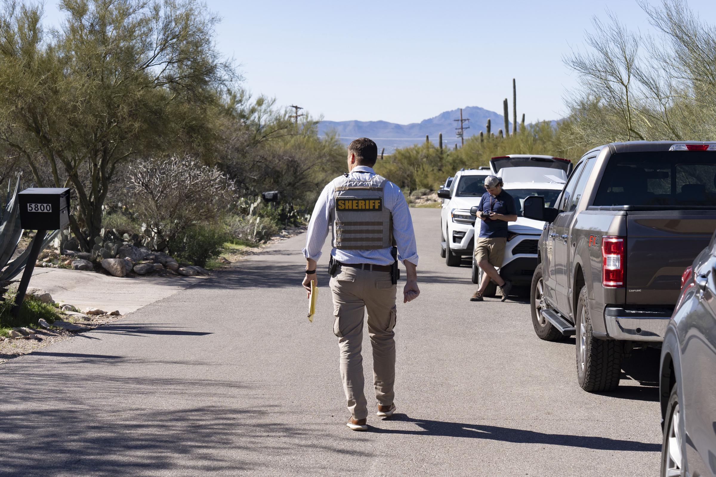 A Pima County Sheriff's deputy walks outside Nancy Guthrie's home in Tucson, Arizona | Source: Getty Images