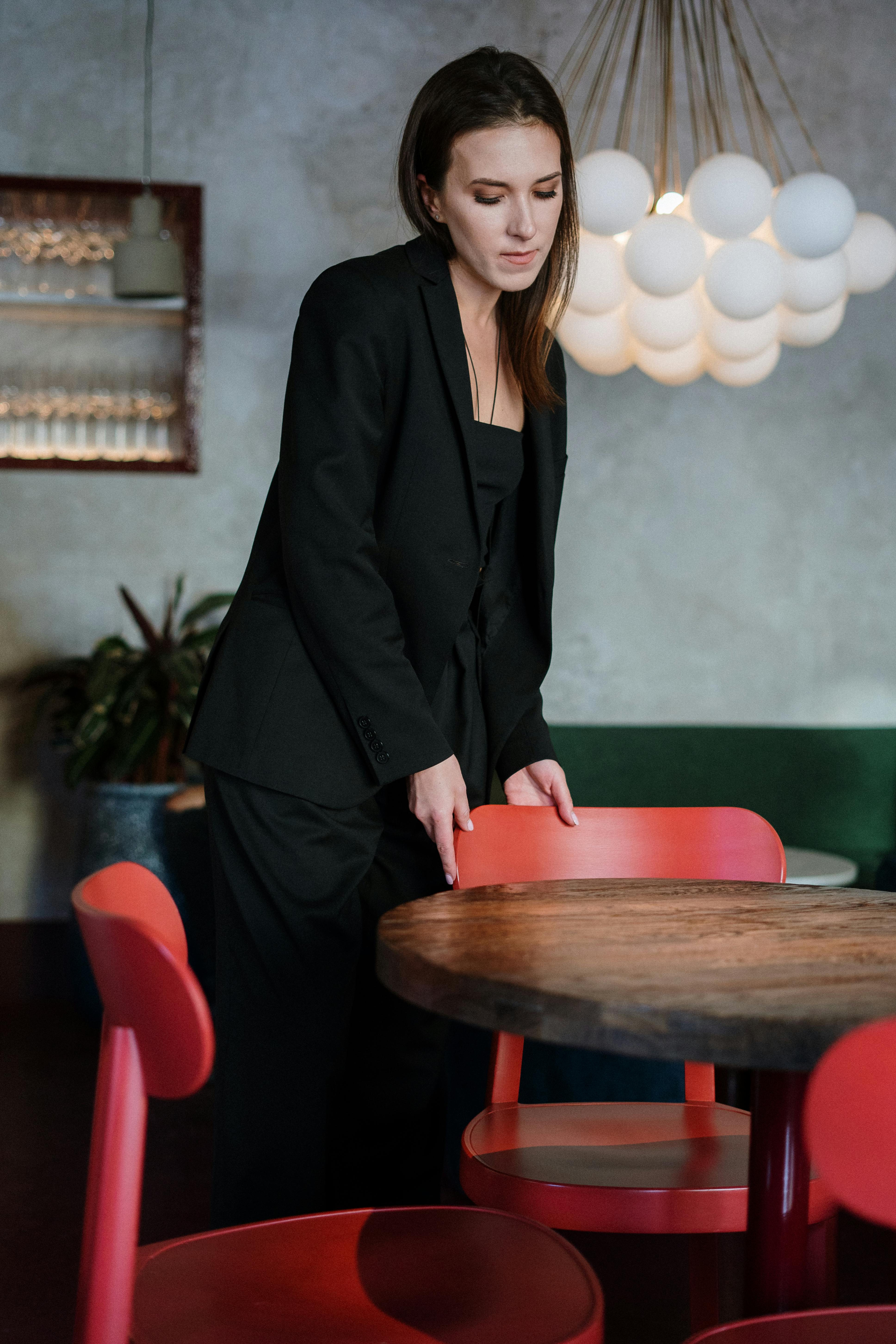 Woman looking solemn while getting up from her chair at an establishment | Source: Pexels