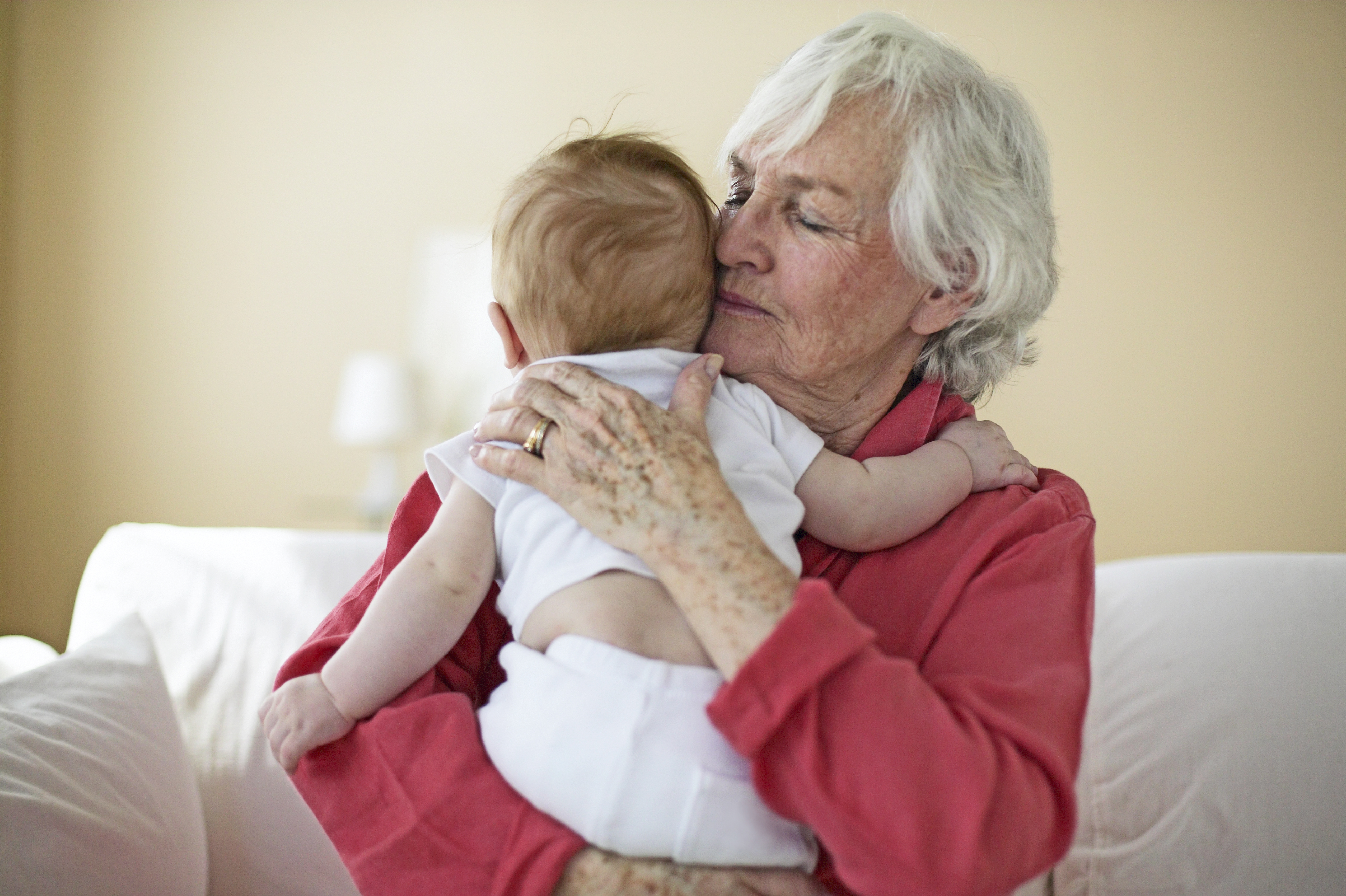 A grandmother hugging a baby | Source: Getty Images