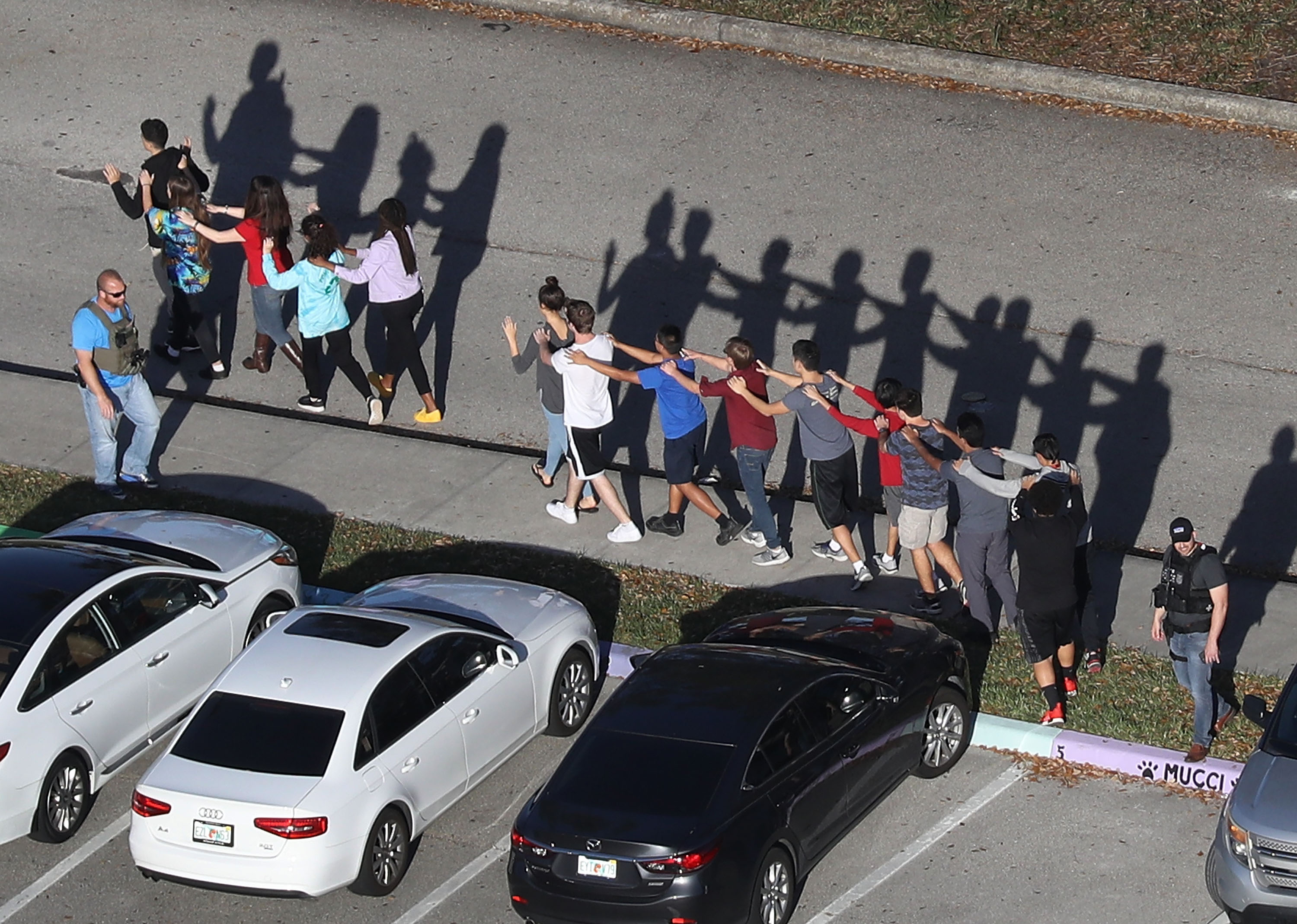 Students are evacuated from Marjory Stoneman Douglas High School after the shooting on February 14, 2018 | Source: Getty Images