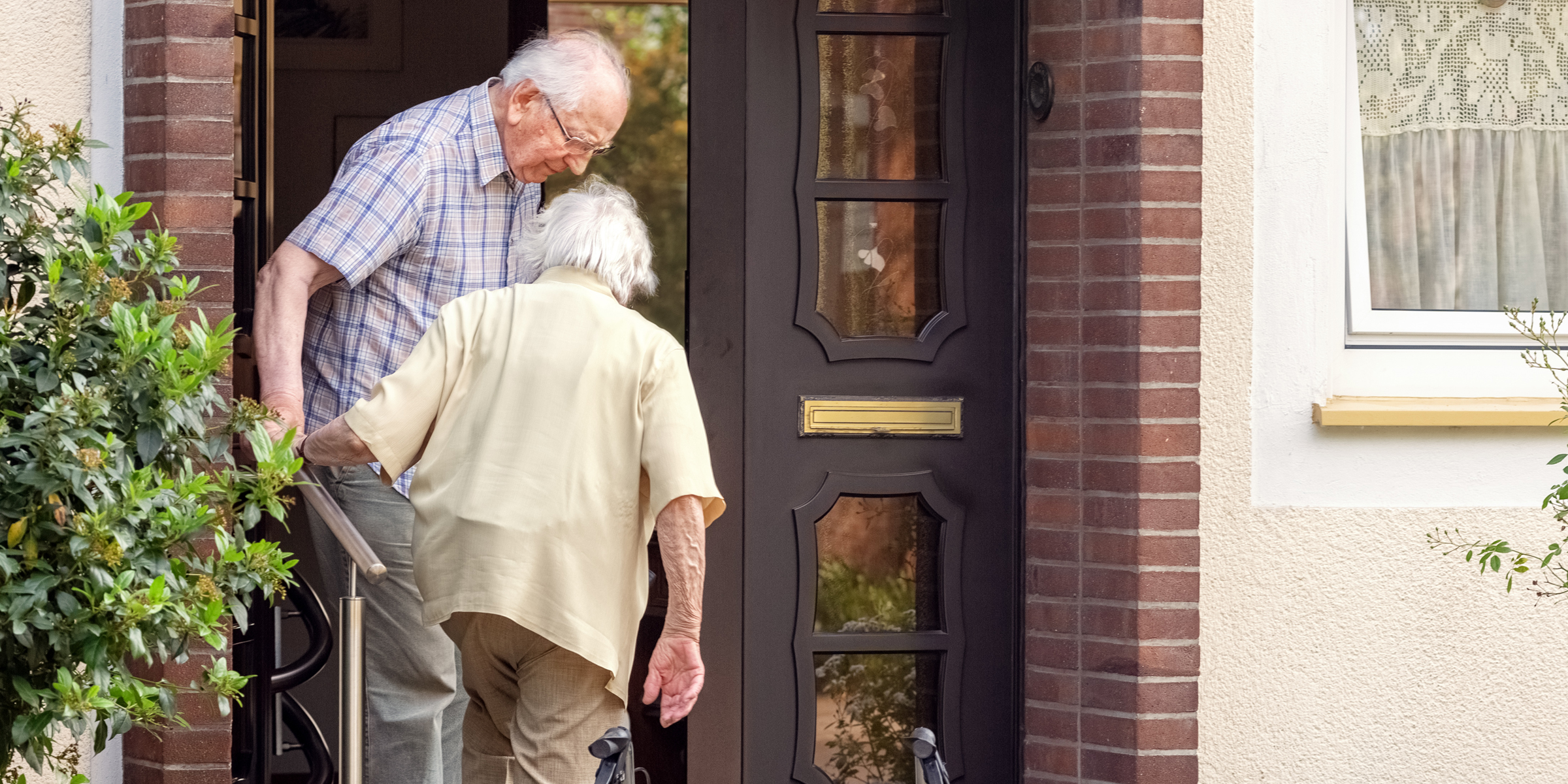 An elderly couple walking up the stairs | Source: Shutterstock