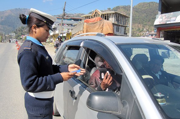 Traffic policewoman checks a driver's documents in Nepal | Photo: Getty Images