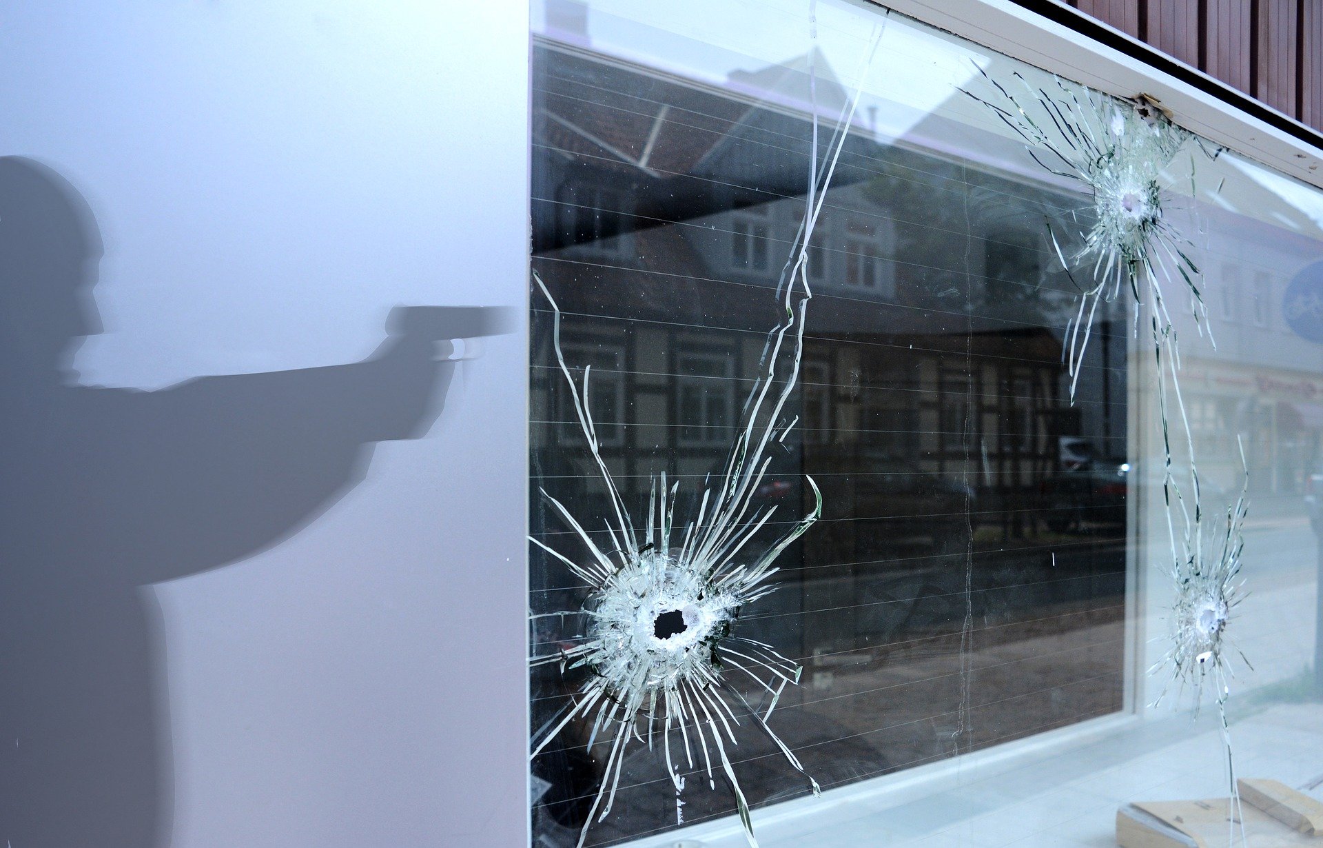 Burglar shooting through the window | Source: Pixabay