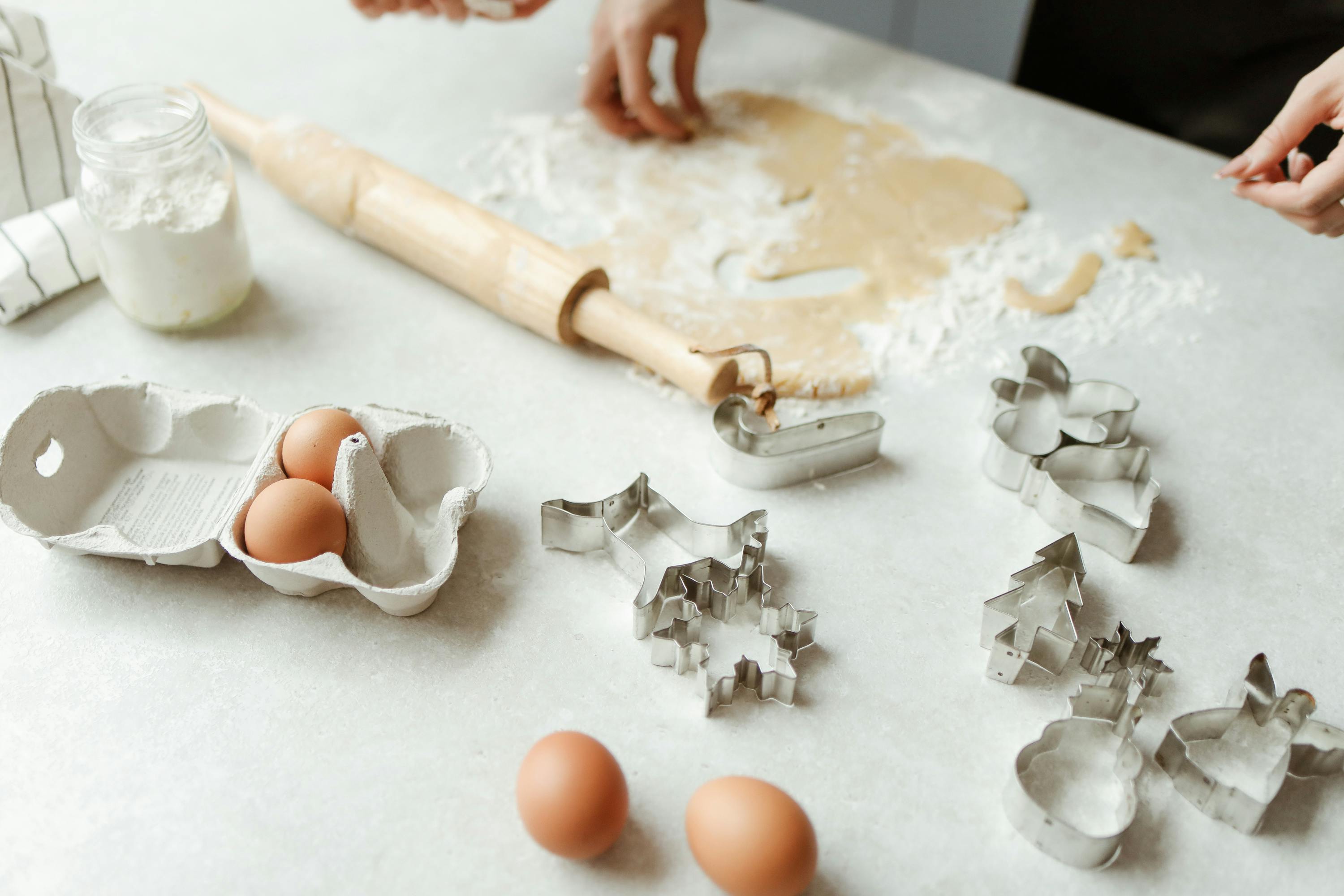 A dirty table with flour, eggs, and baking molds | Source: Pexels