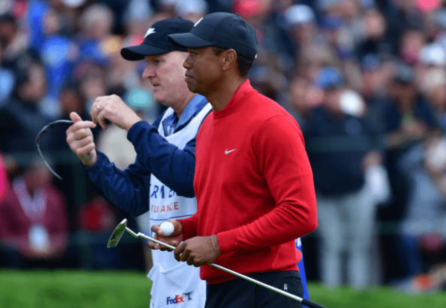  Tiger Woods and his caddie Joe LaCava walks from the 18th green during tthe Farmers Insurance Open, at Torrey Pines South, on January 26, 2020, in San Diego, California | Source:  Donald Miralle/Getty Images