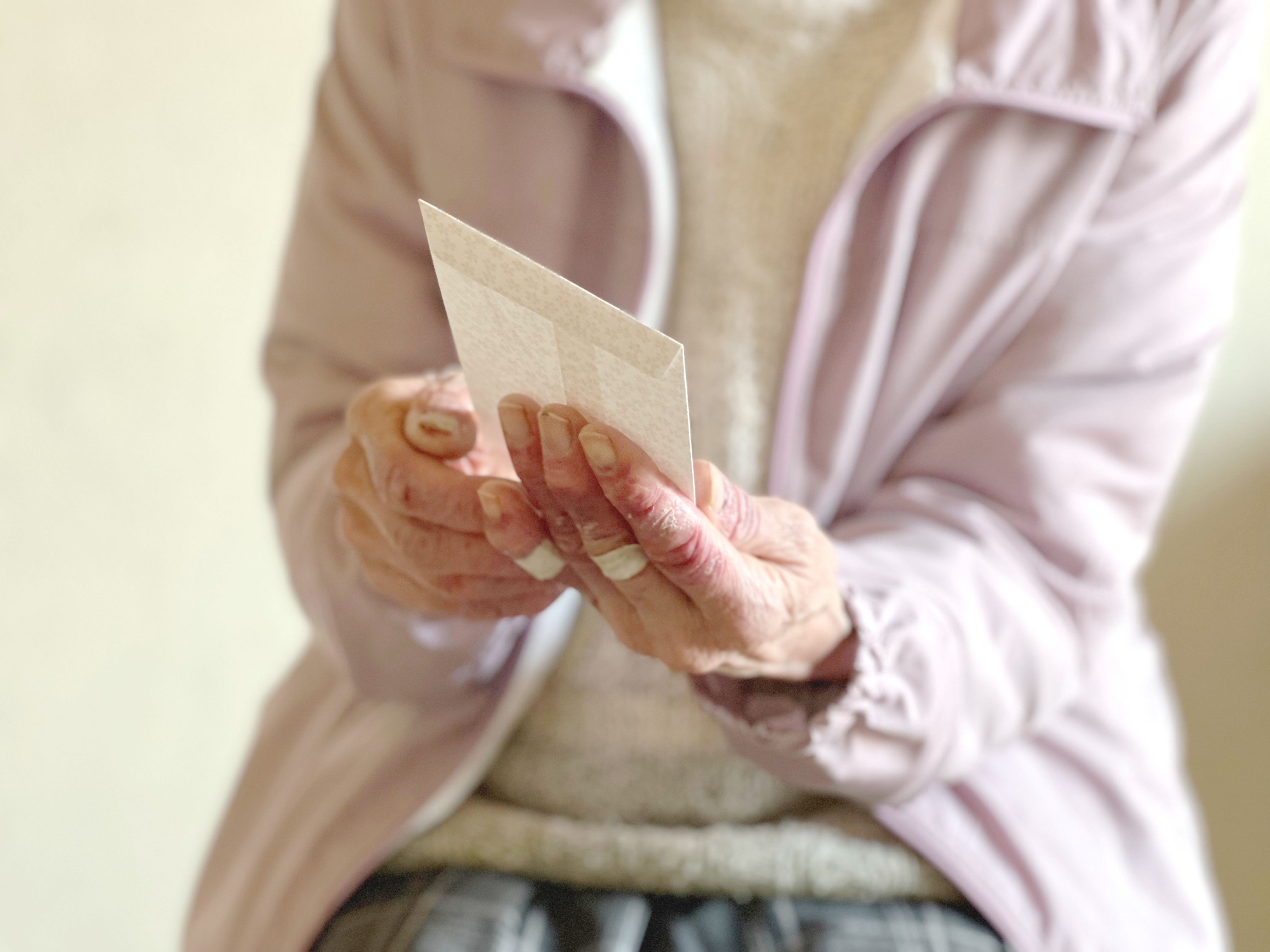 Elderly woman holding an envelope | Source: Shutterstock