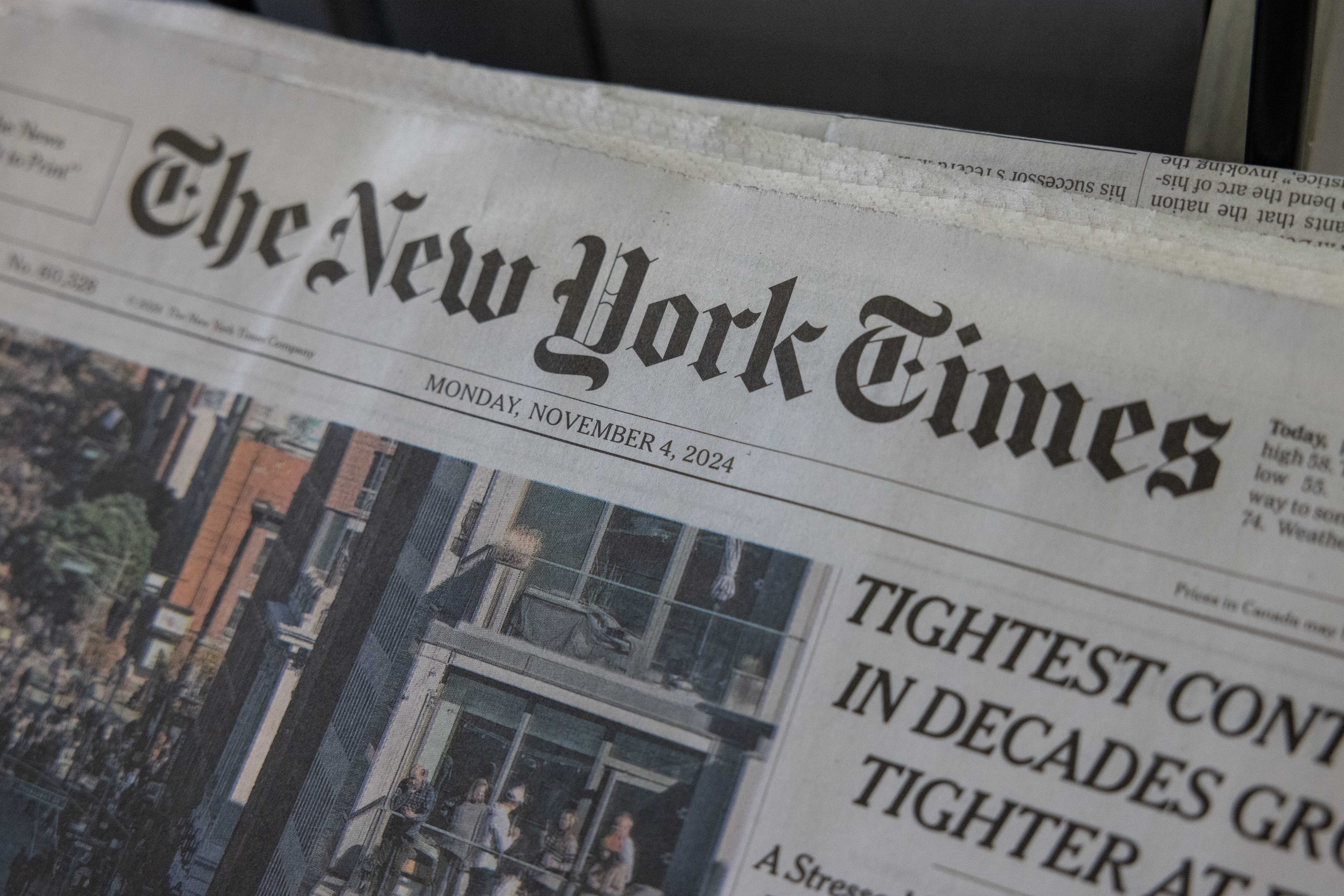 Copies of The New York Times newspaper on a news stand in New York on November 4, 2024 | Source: Getty Images