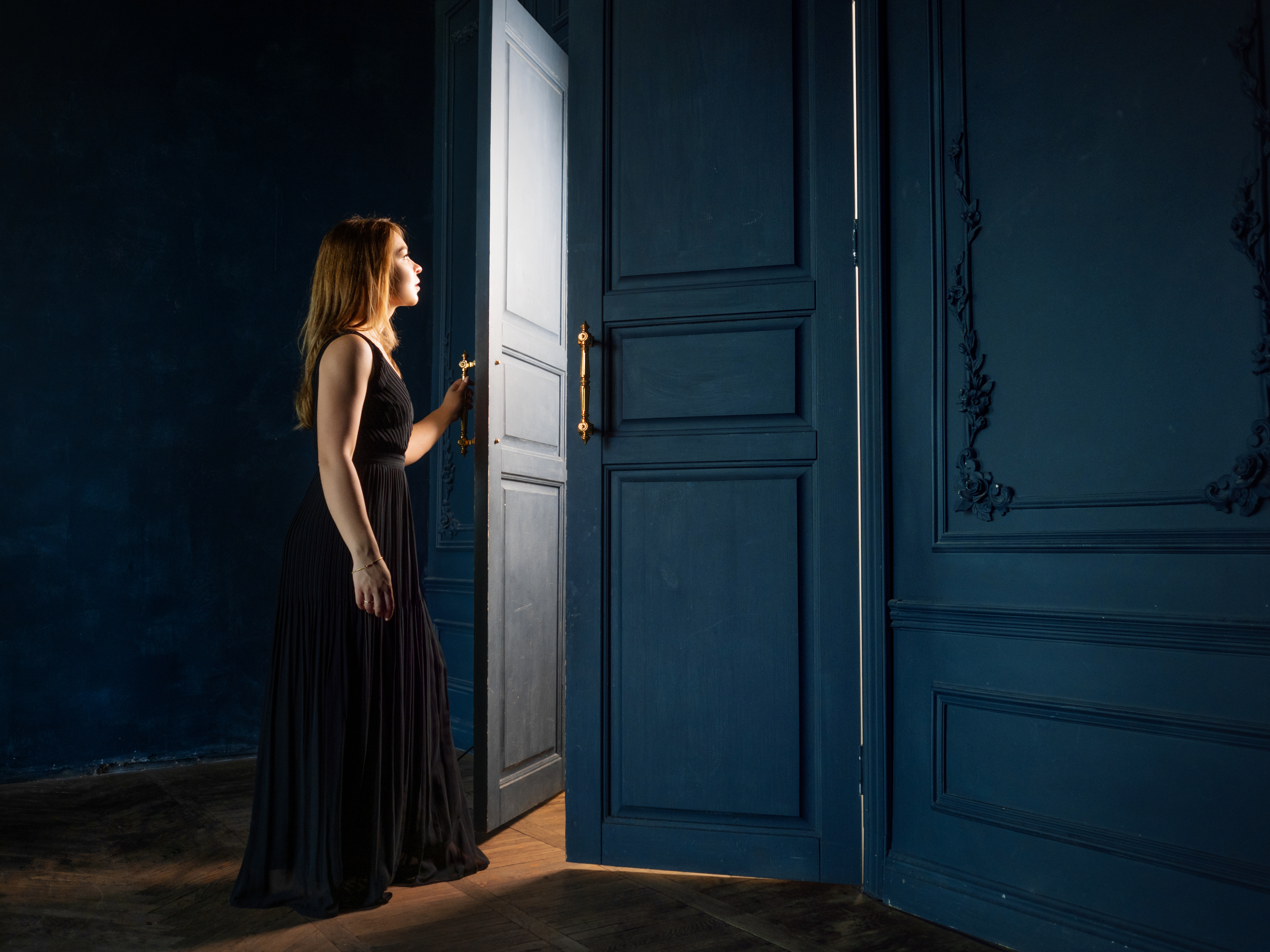 Woman opening a door to a room | Source: Shutterstock