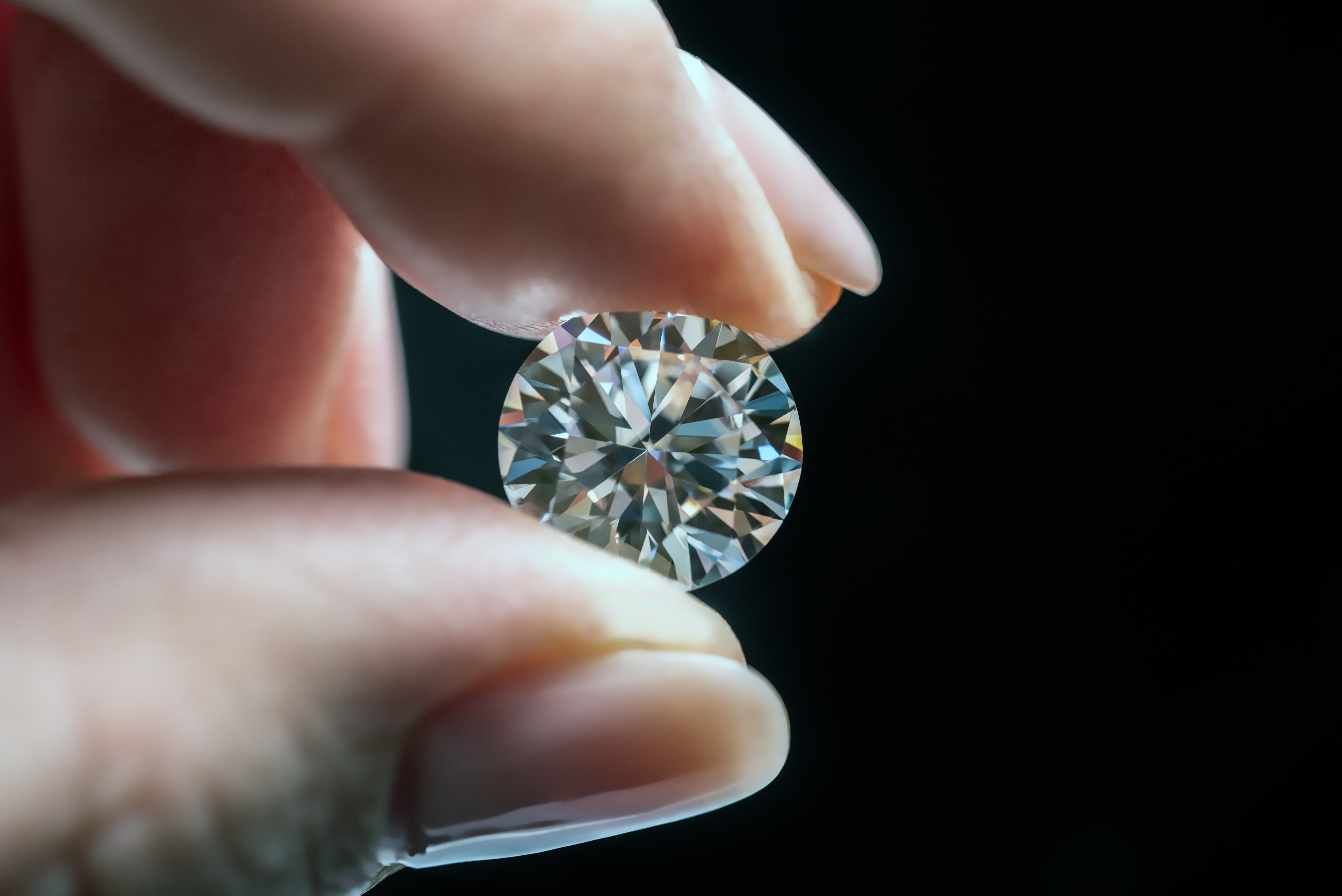 Female Hand Holding Diamond | Source: Shutterstock.com