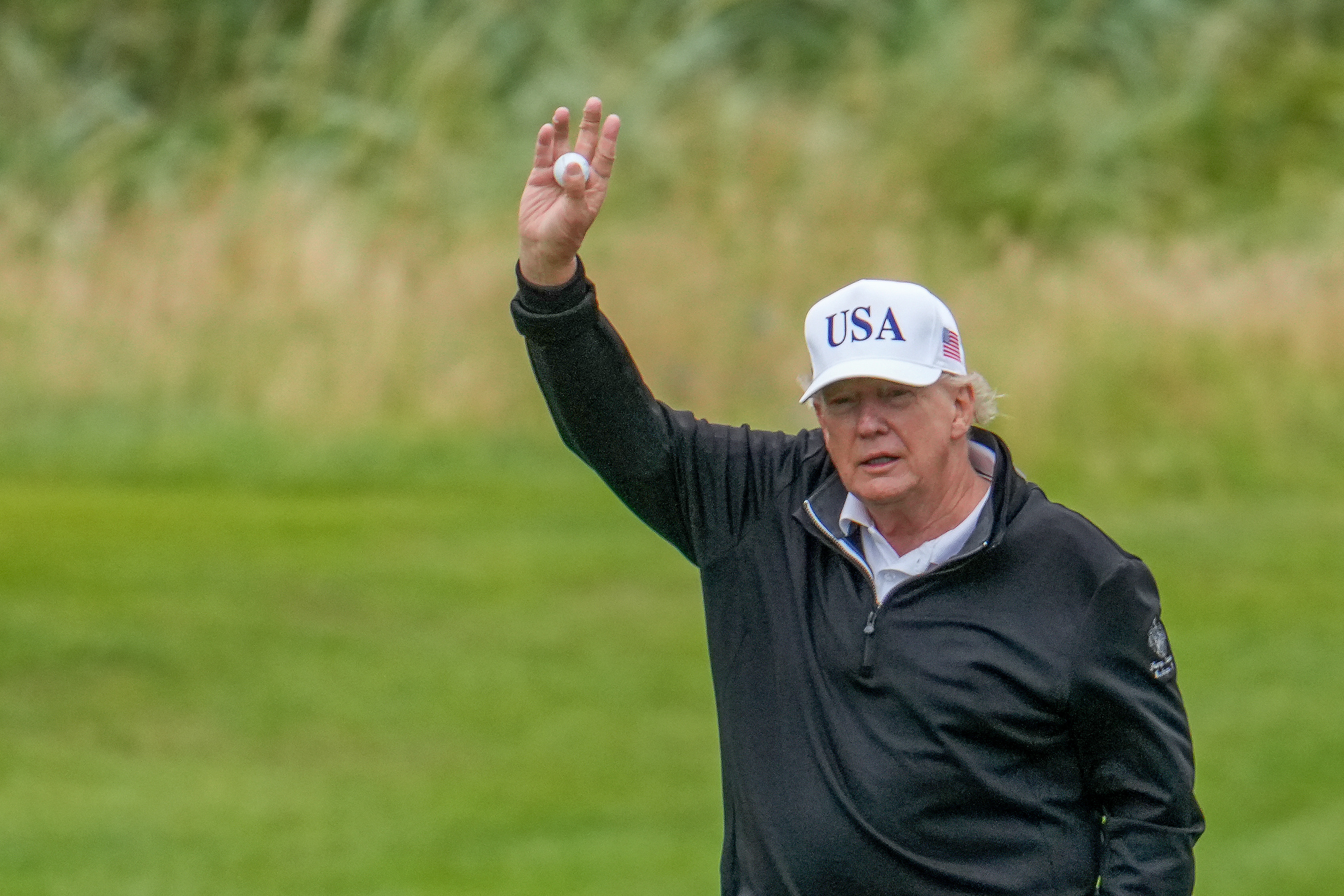 President Donald Trump holds a golf ball in his hand at the new golf course resort in Turnberry during his visit to Scotland on July 27, 2025 | Source: Getty Images