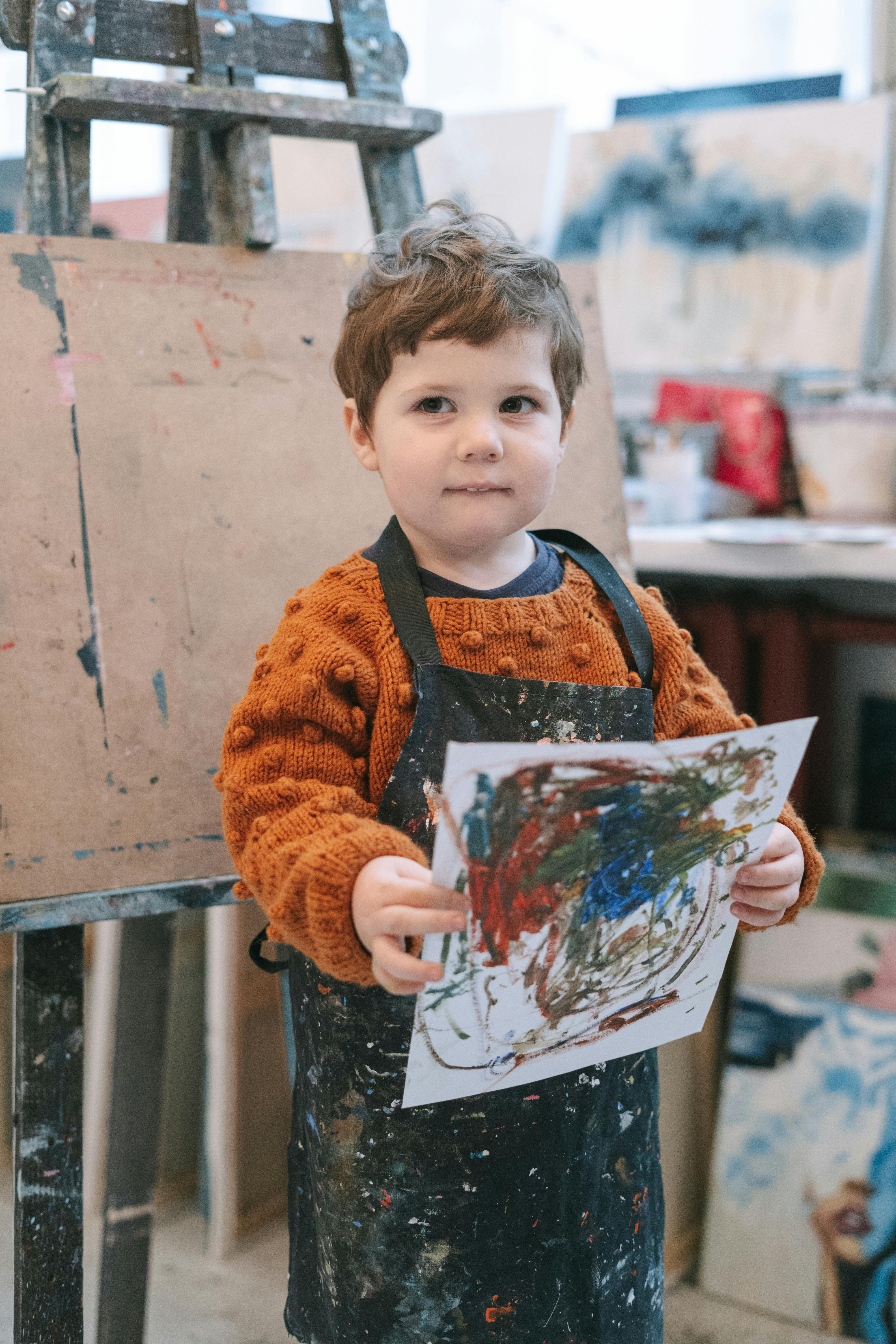A boy with his drawing | Source: Pexels