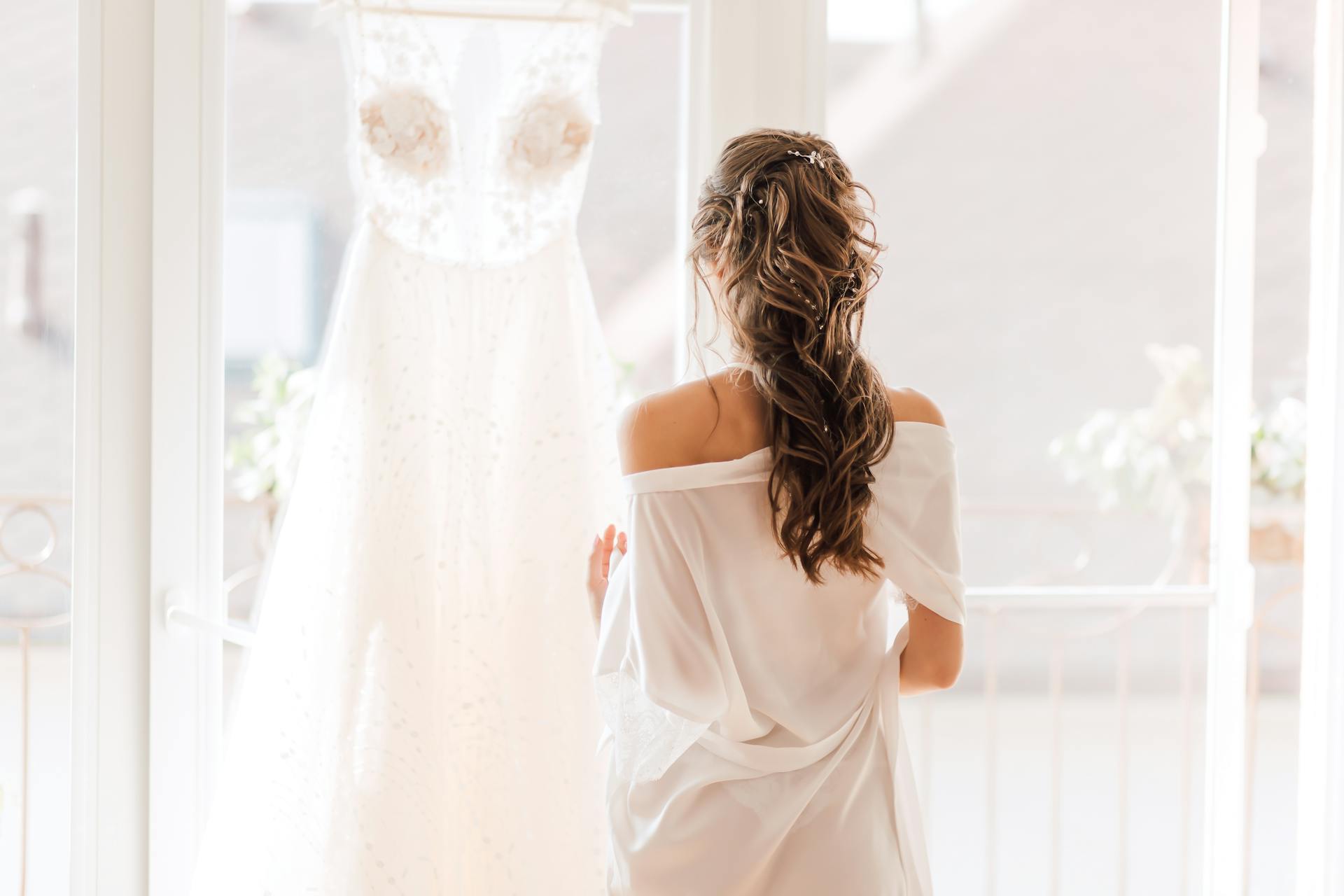 A bride standing in front of a wedding dress | Source: Pexels