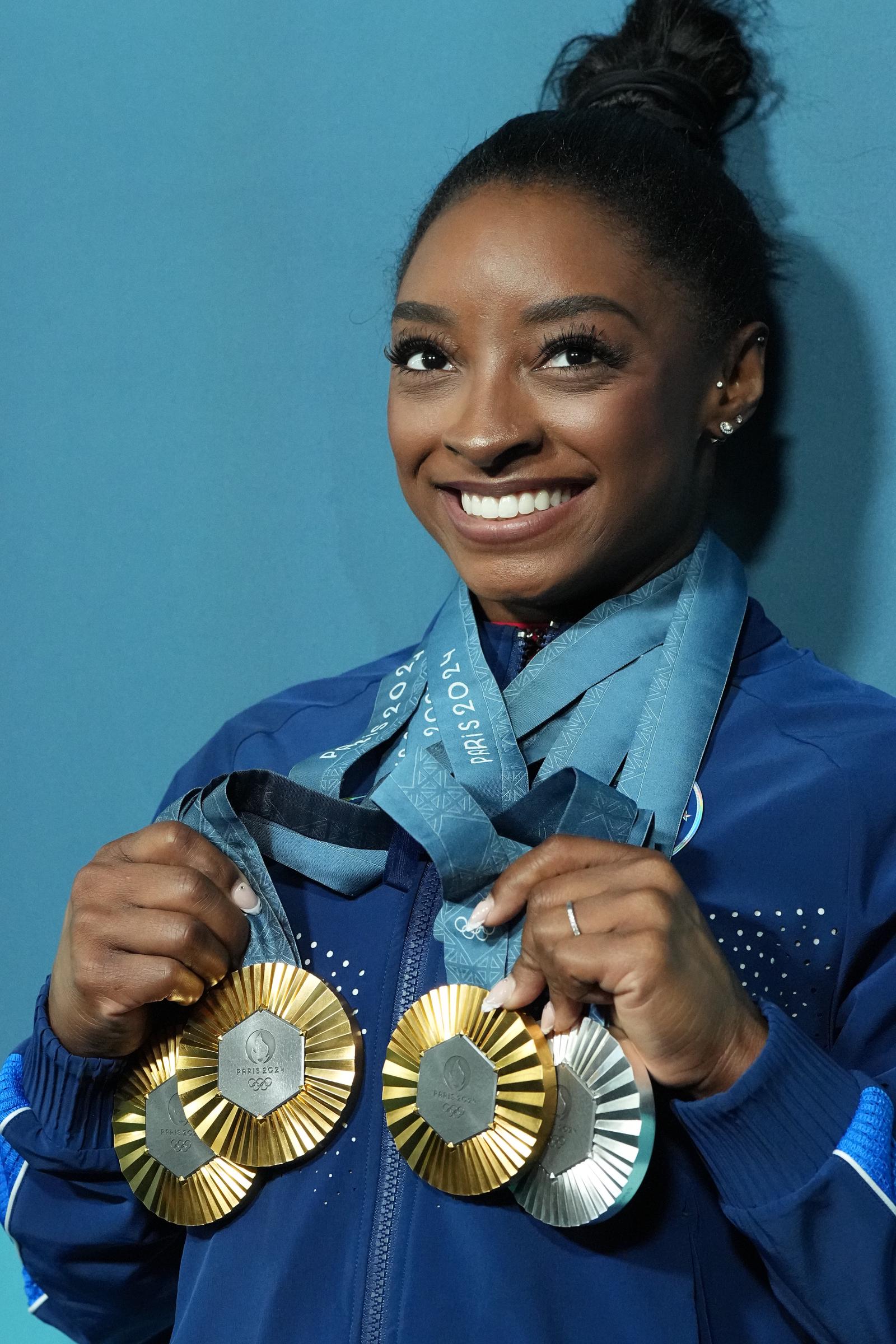 Simone Biles poses with her three gold and one silver medal after the Women's Floor Exercise Final at the Paris 2024 Olympics on August 5, 2024 | Source: Getty Images