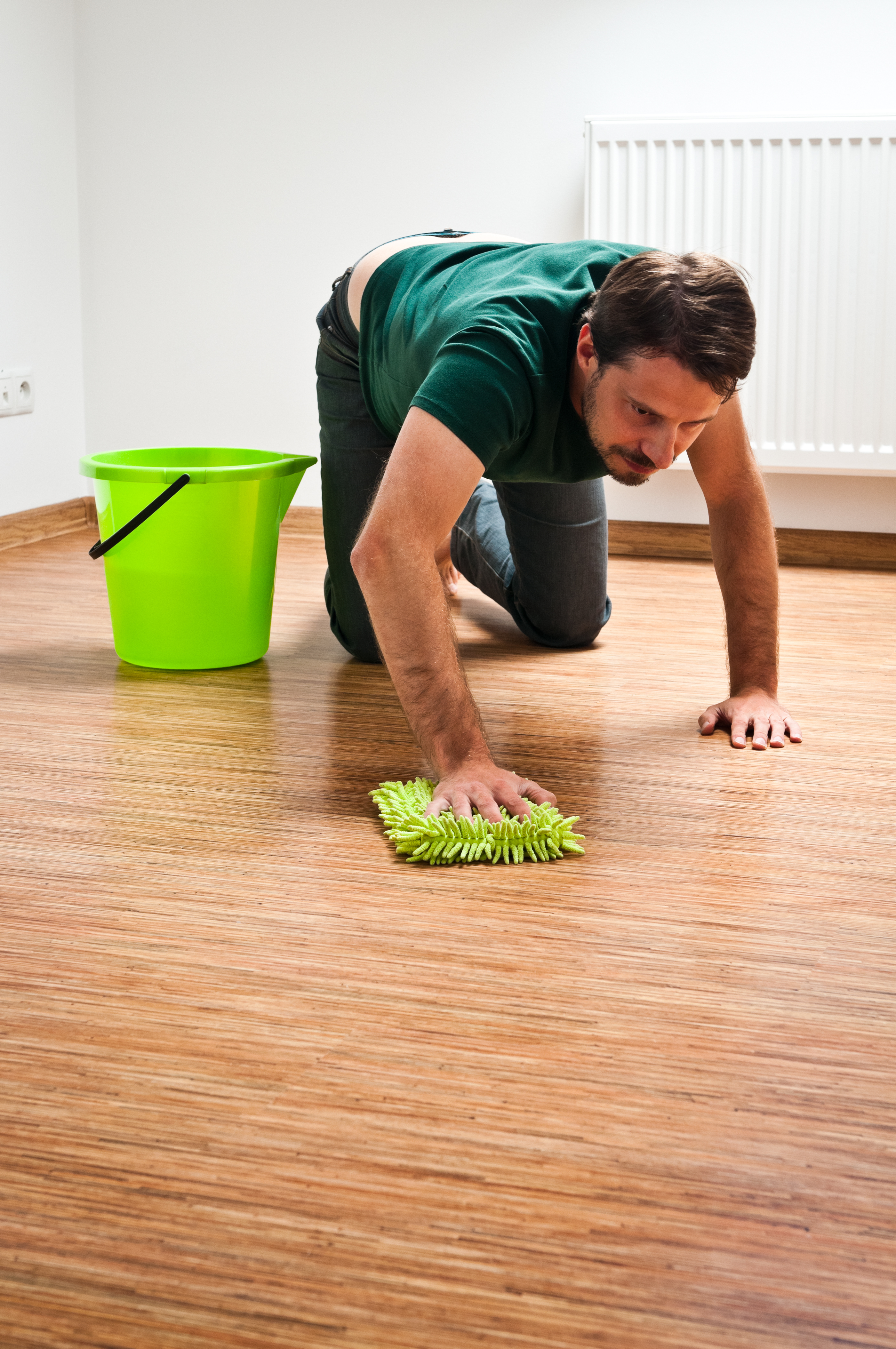A man cleaning the floors of his home | Source: Getty Images