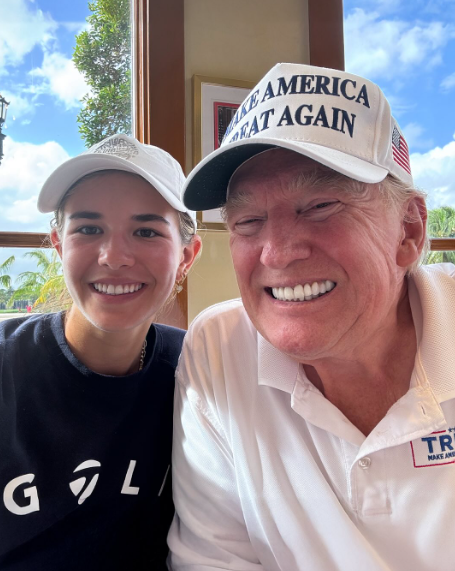 On November 10, he poses indoors for a selfie with his granddaughter Kai Trump. Wearing a white "Make America Great Again" cap, Trump flashes a wide smile, showing a deep red tone on his cheeks that fades sharply around the edges of his face. | Source: Instagram/kaitrumpgolfer
