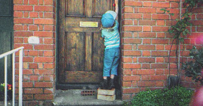 A kid opening a door | Source: Shutterstock