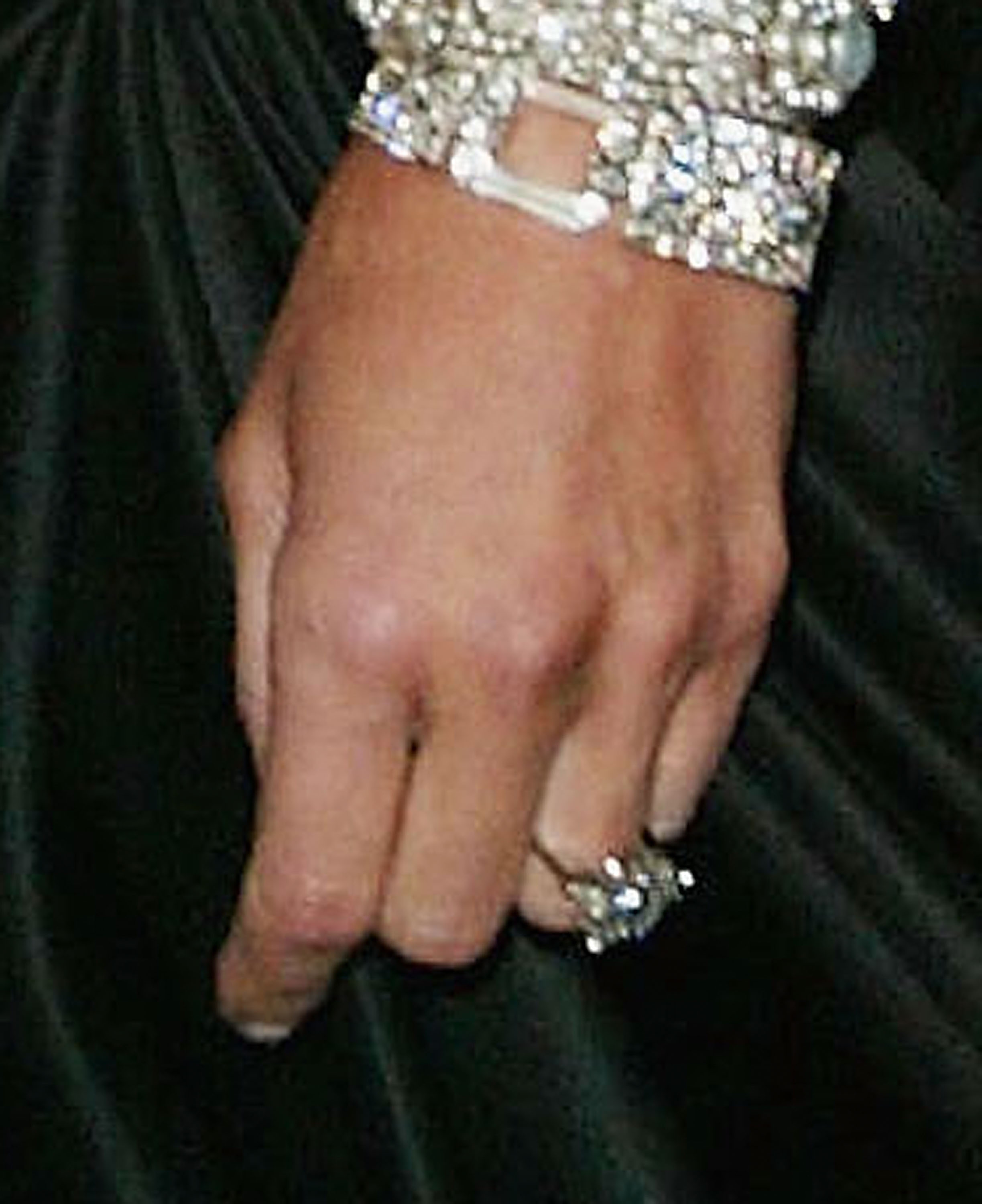 In a close-up photo taken at the 2004 Costume Institute Gala, Melania's left hand is elegantly positioned to display her dazzling engagement ring from Donald. The emerald-cut diamond gleams with striking clarity and is paired with a matching diamond bracelet.