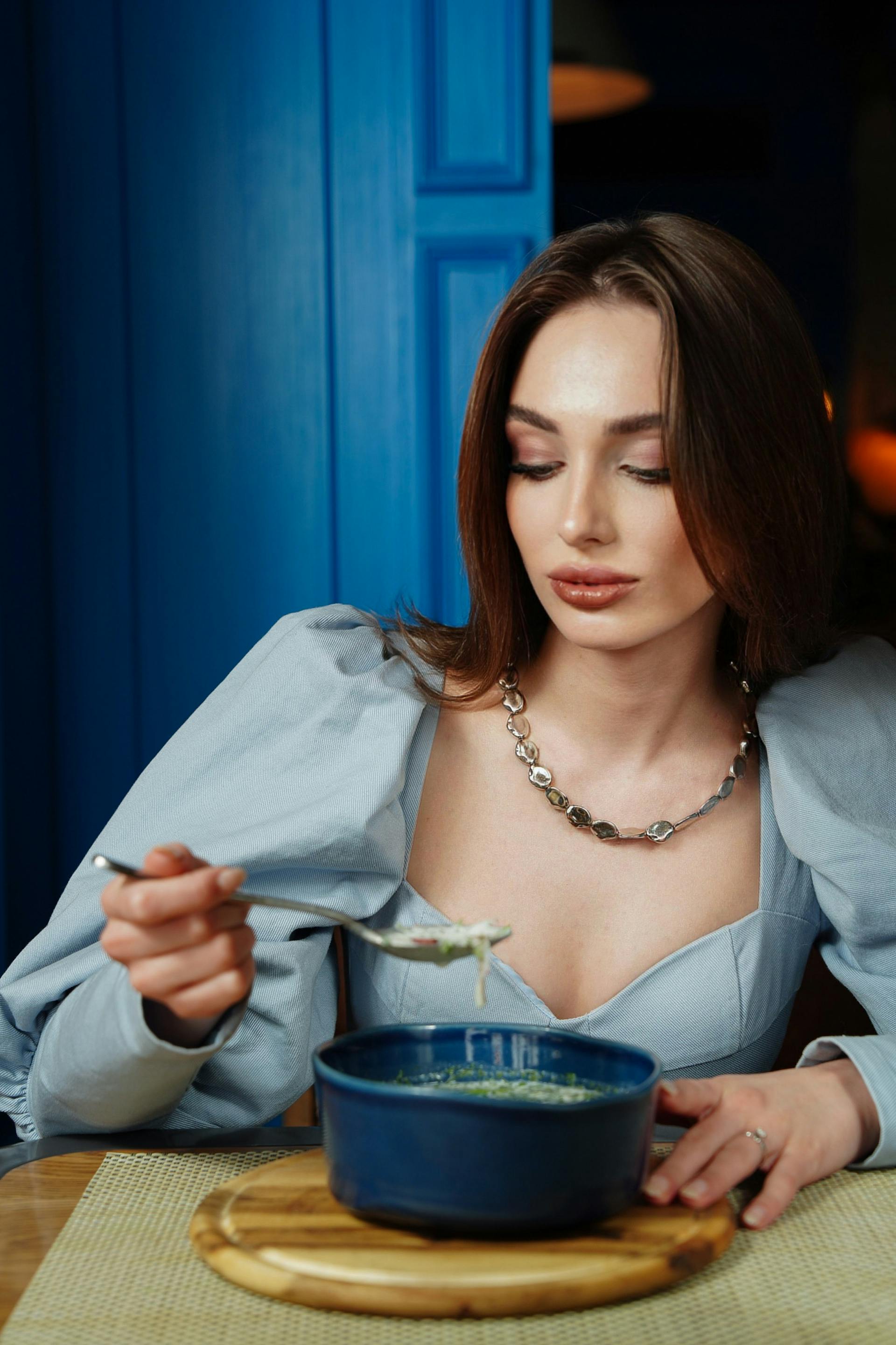 A woman looking doubtfully at her meal | Source: Pexels