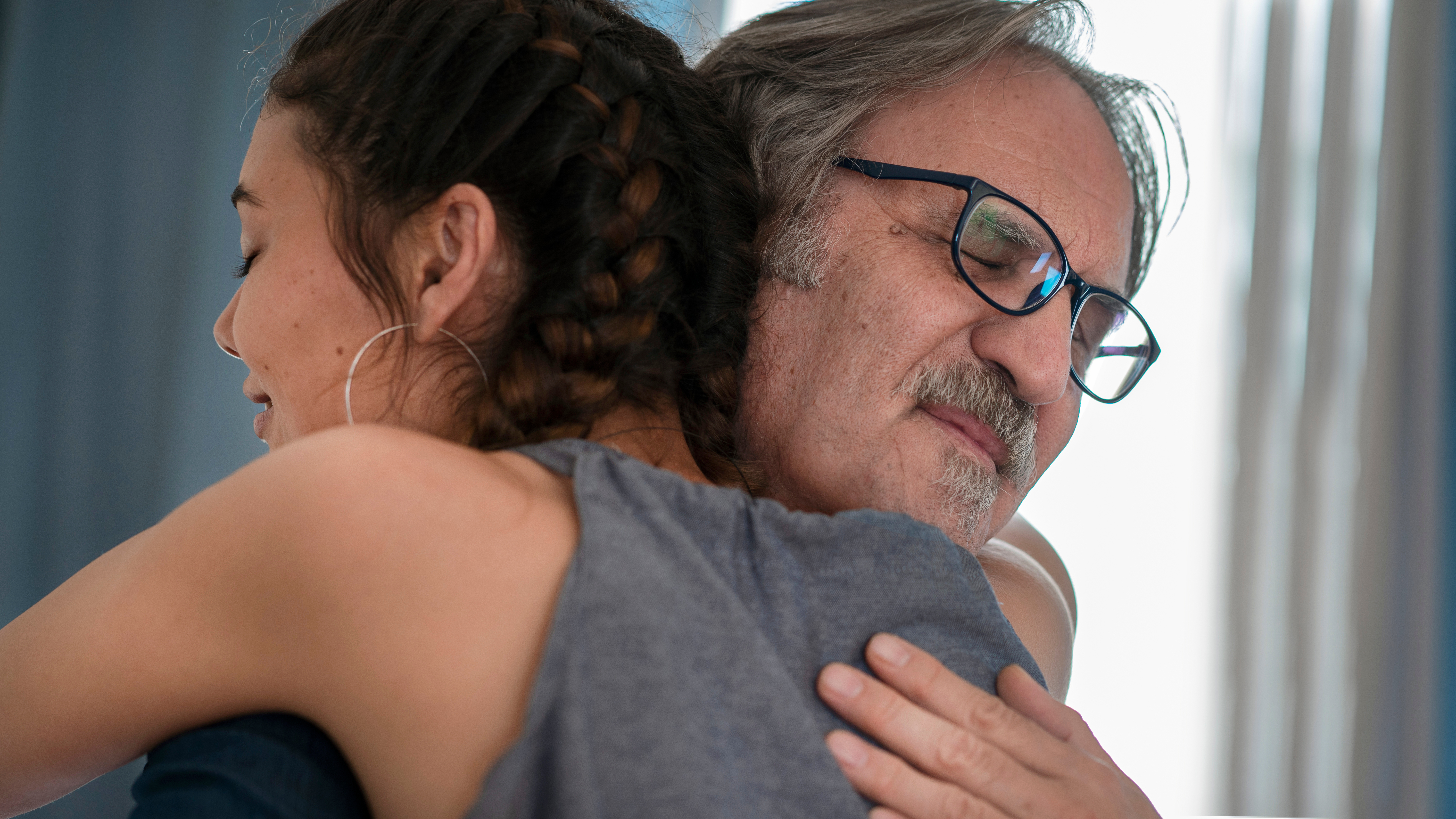 A senior father embracing his adult daughter | Source: Shutterstock
