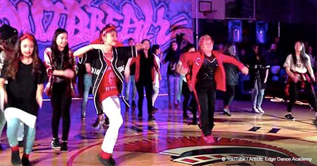 Students do an energetic dance but their 60-year-old teacher steals the spotlight