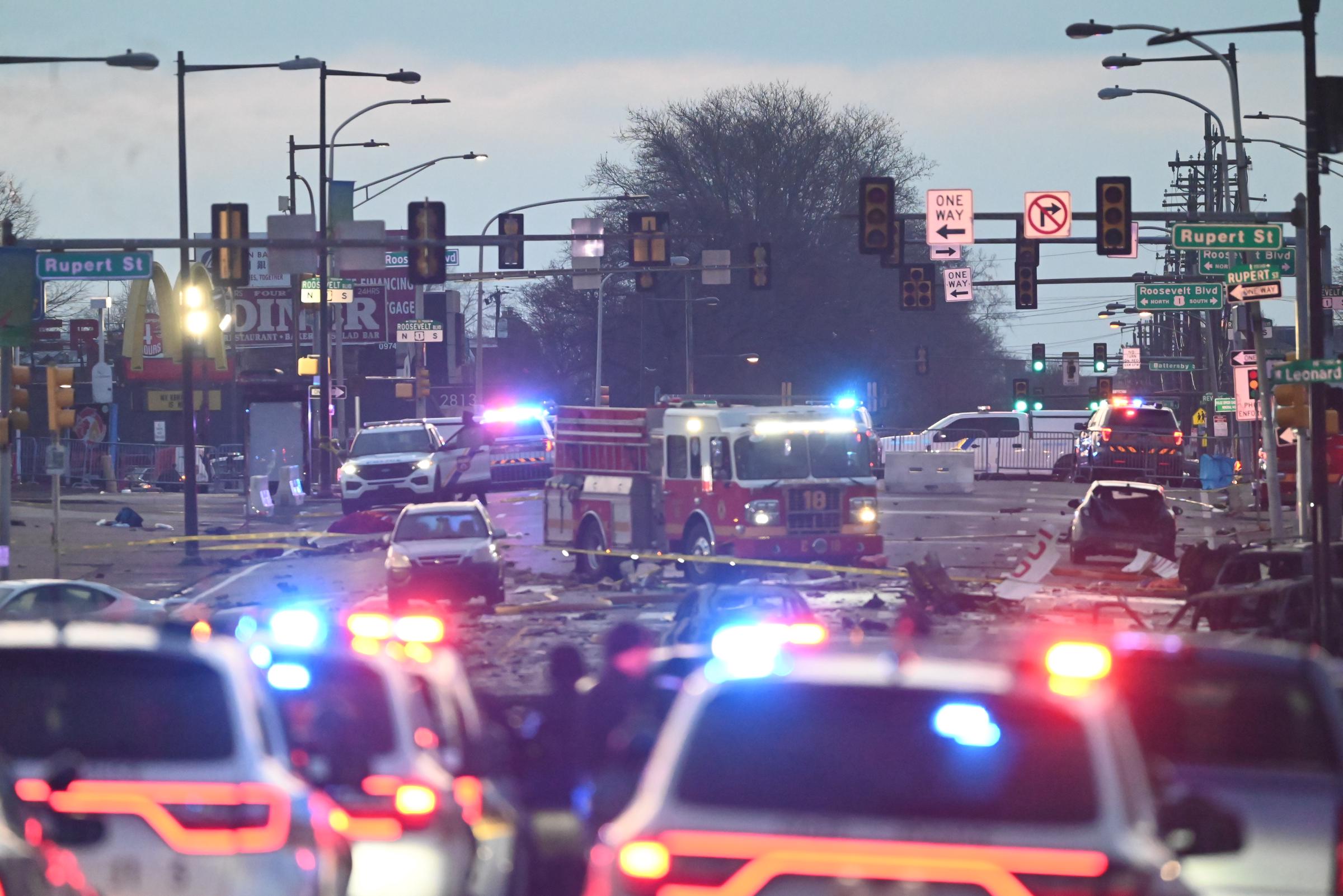 Ambulance trucks and police cars at the crash site the morning after the tragedy. | Source: Getty Images