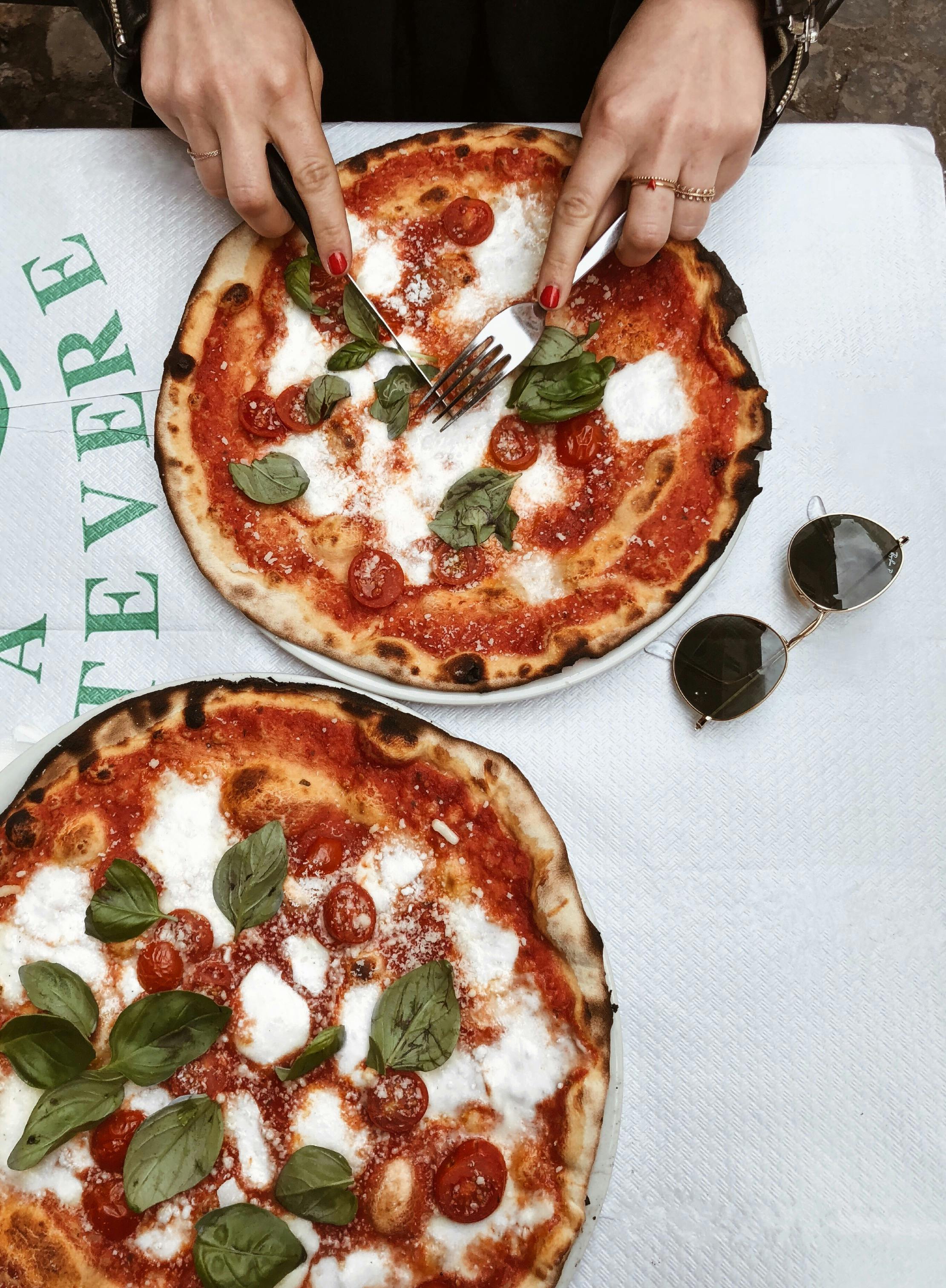 A woman eating a pizza | Source: Pexels