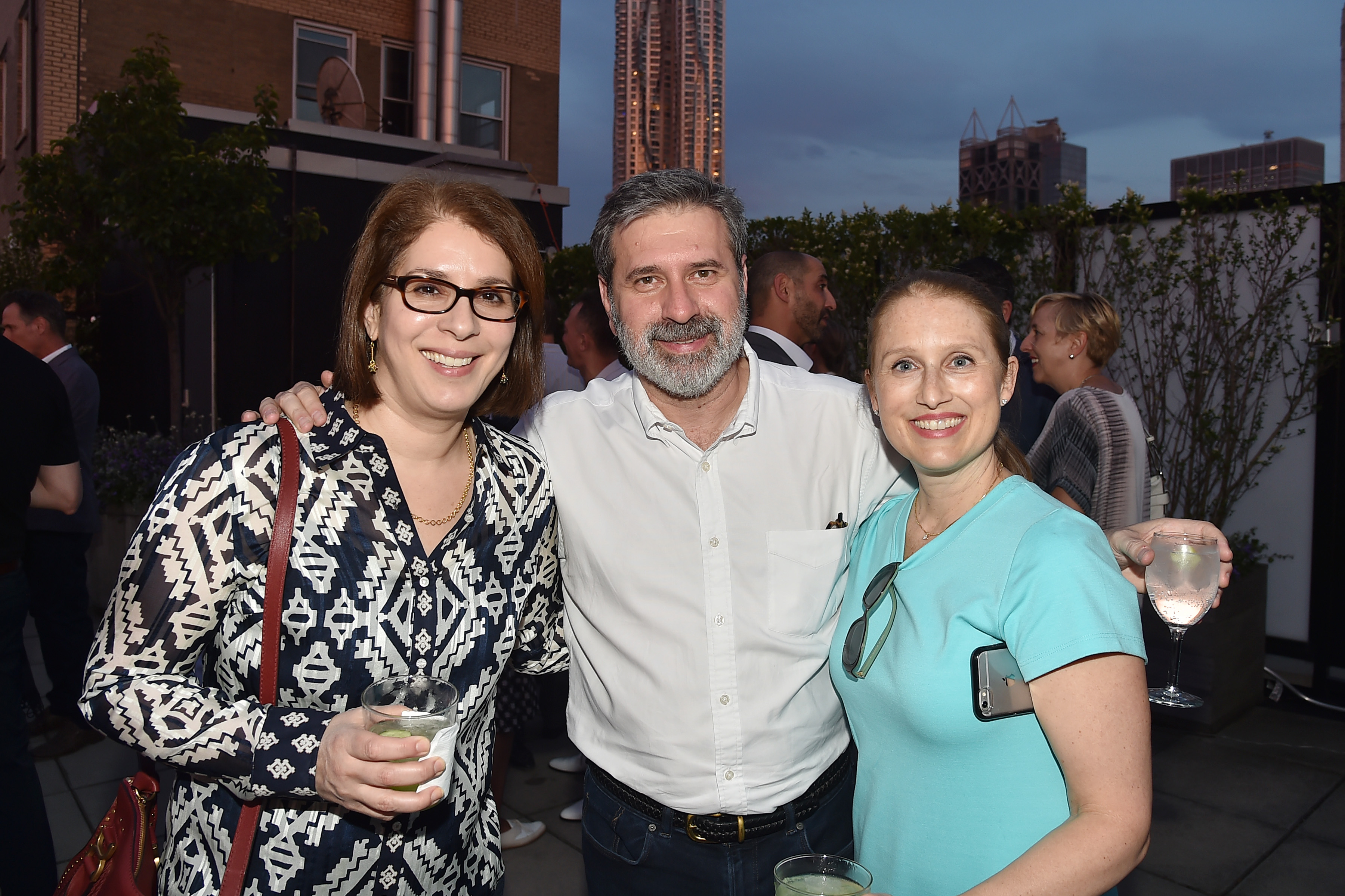 Neda and Christopher Morvillo posing for a picture with a guest named Leann Graeff at the Summer Birthday Cocktails For Lawrence Kaplan event in New York City on June 21, 2018 | Source: Getty Images