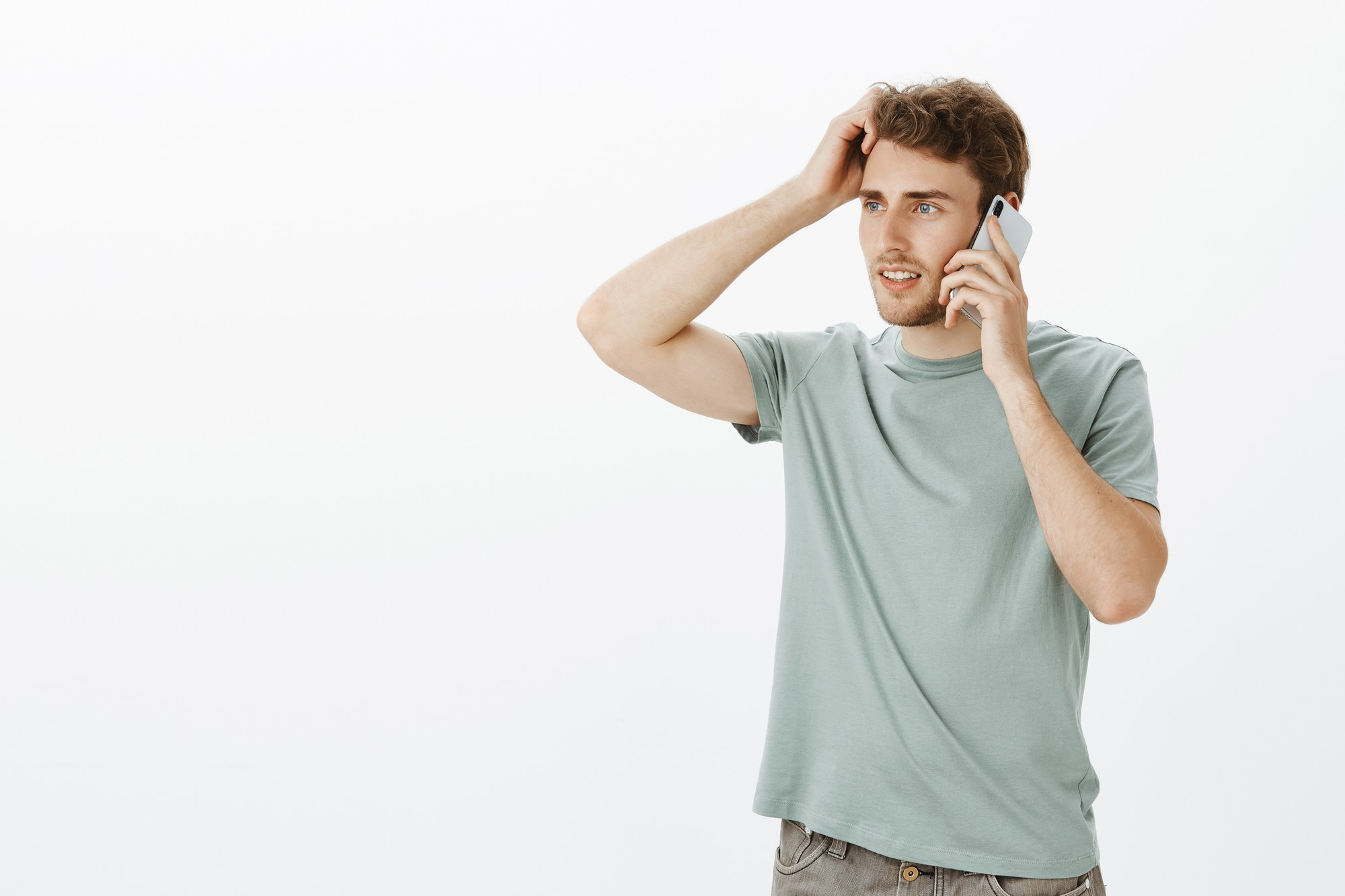 A man is at a loss for words while talking on the phone with someone | Source: Freepik